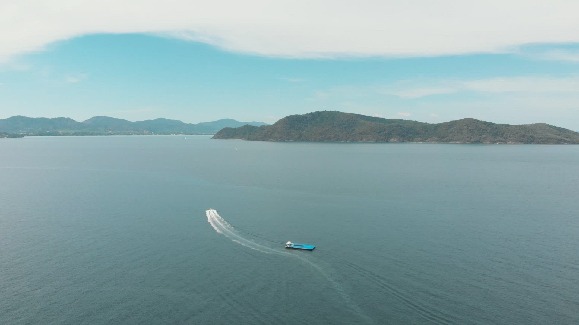 Speed Boat cruising through the waters between Koh Hey (Coral Island) and mainland Phuket, Thailand 