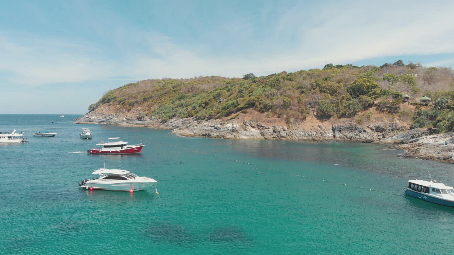 Moored fishing boats and tourism Yachts resting above the paradisiac shallow water in Ko Racha Yai I