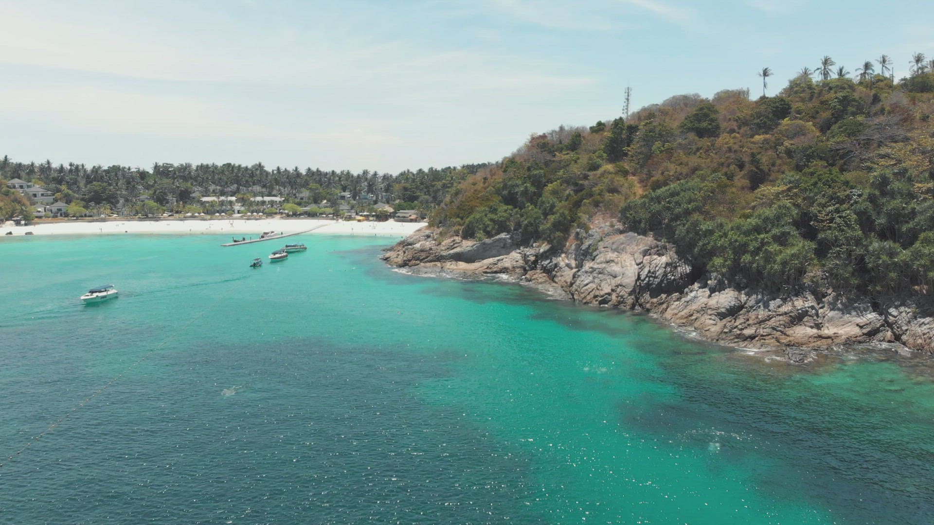 Small bay of paradisiac emerald clear waters anchoring tourist boats in Ko Racha Yai Island, off the