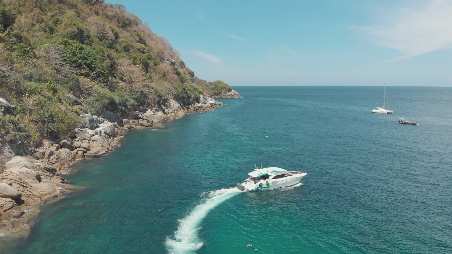 Recreational motorboat makes a turn at sea. Tropical waters. Tracking shot