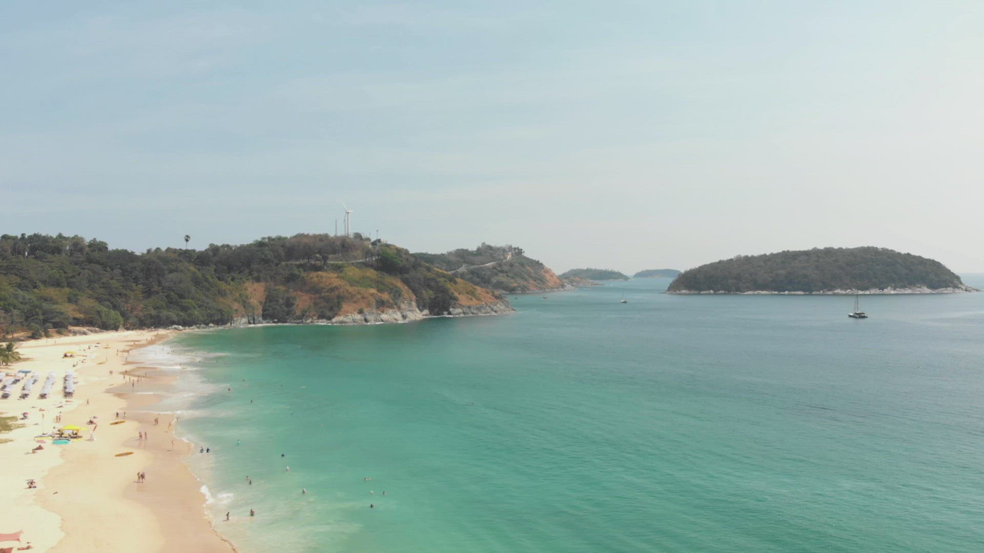 View to Promthep Cape from Tropical golden sandy Nai harn beach, in Phuket, Thailand - Aerial Fly-ov