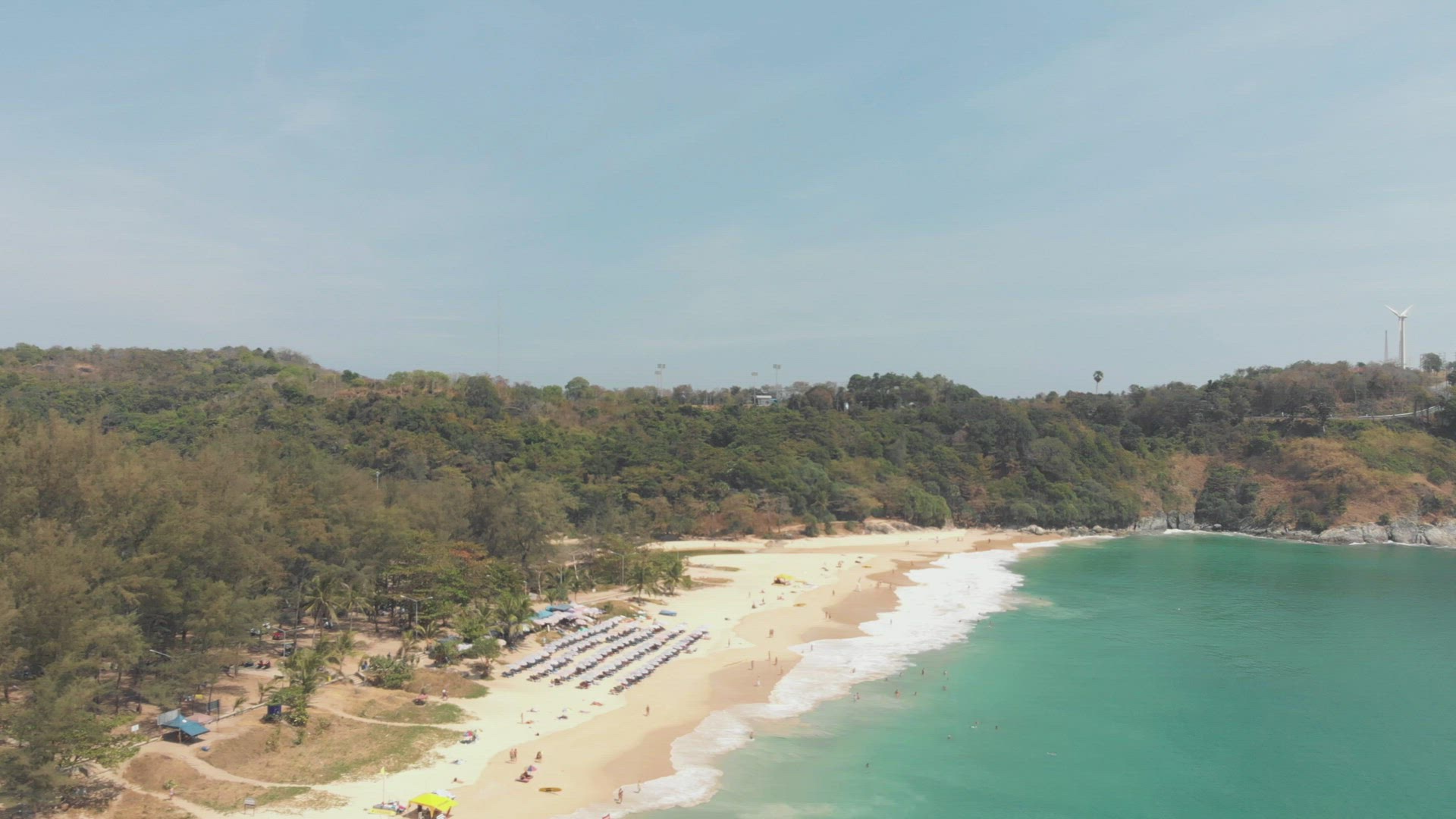 Unrecognisable people enjoying the white sand tropical beaches of Phuket, Thailand 