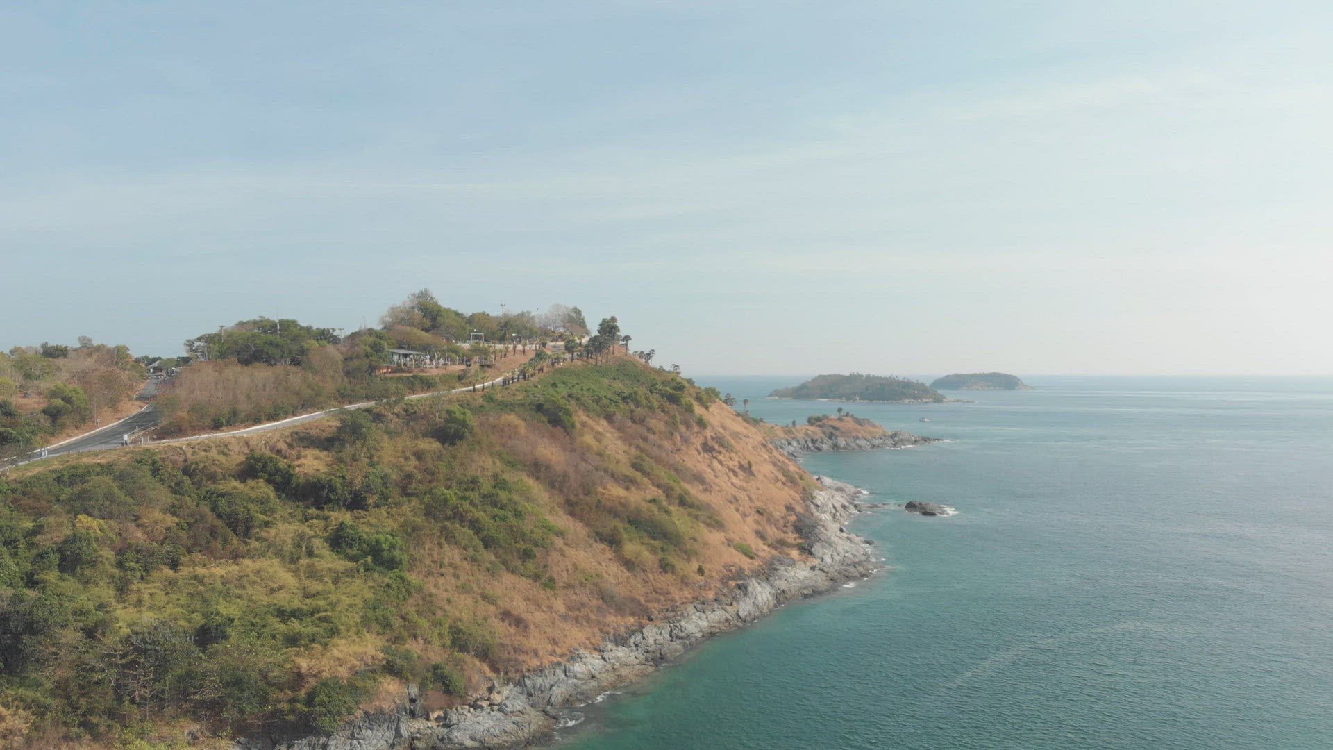 Windmill Viewpoint over Steep hill carrying the road to Promphet Cape, in Phuket, Thailand - Aerial 