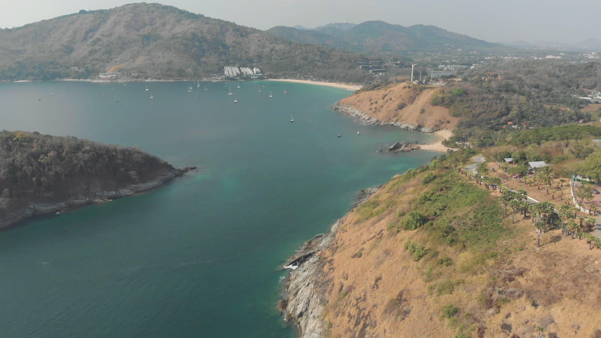 wide view over Nai harn Reef and Nai Harn Beach in southern Phuket, in Thailand - Aerial Fly-over sh