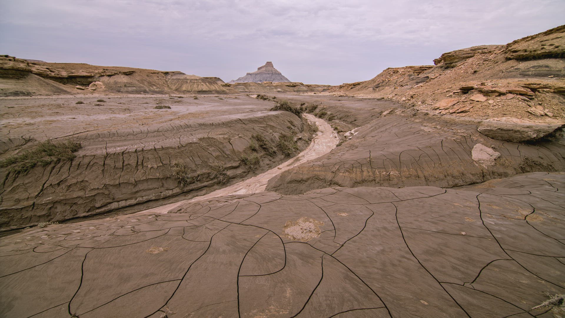 Overlooking cracked mud landscape drying out after flash flood at Factory Butte