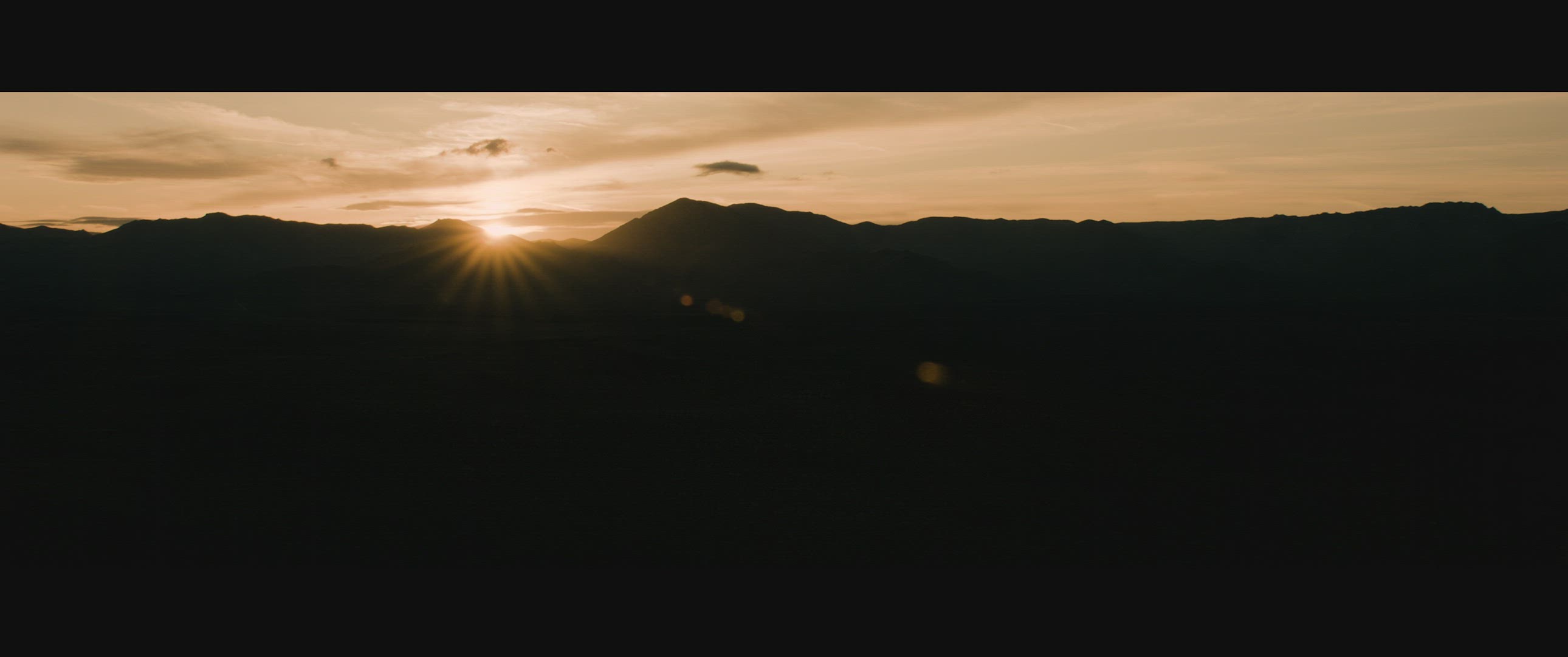 Sunrise over desert mountains