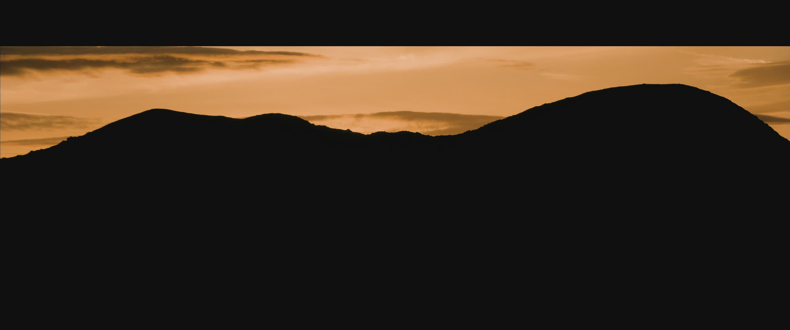 Aerial sun of sunset and silhouetted mountains
