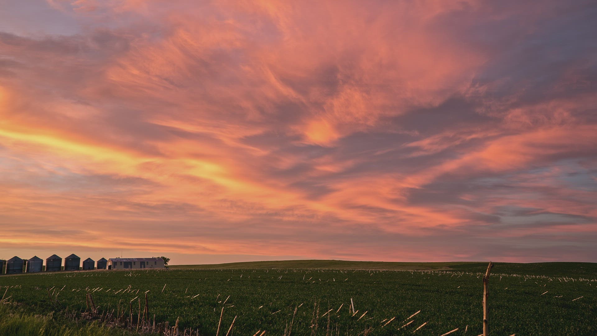 Colorful timelapse sunset over grain silos in the plains of South Dakota