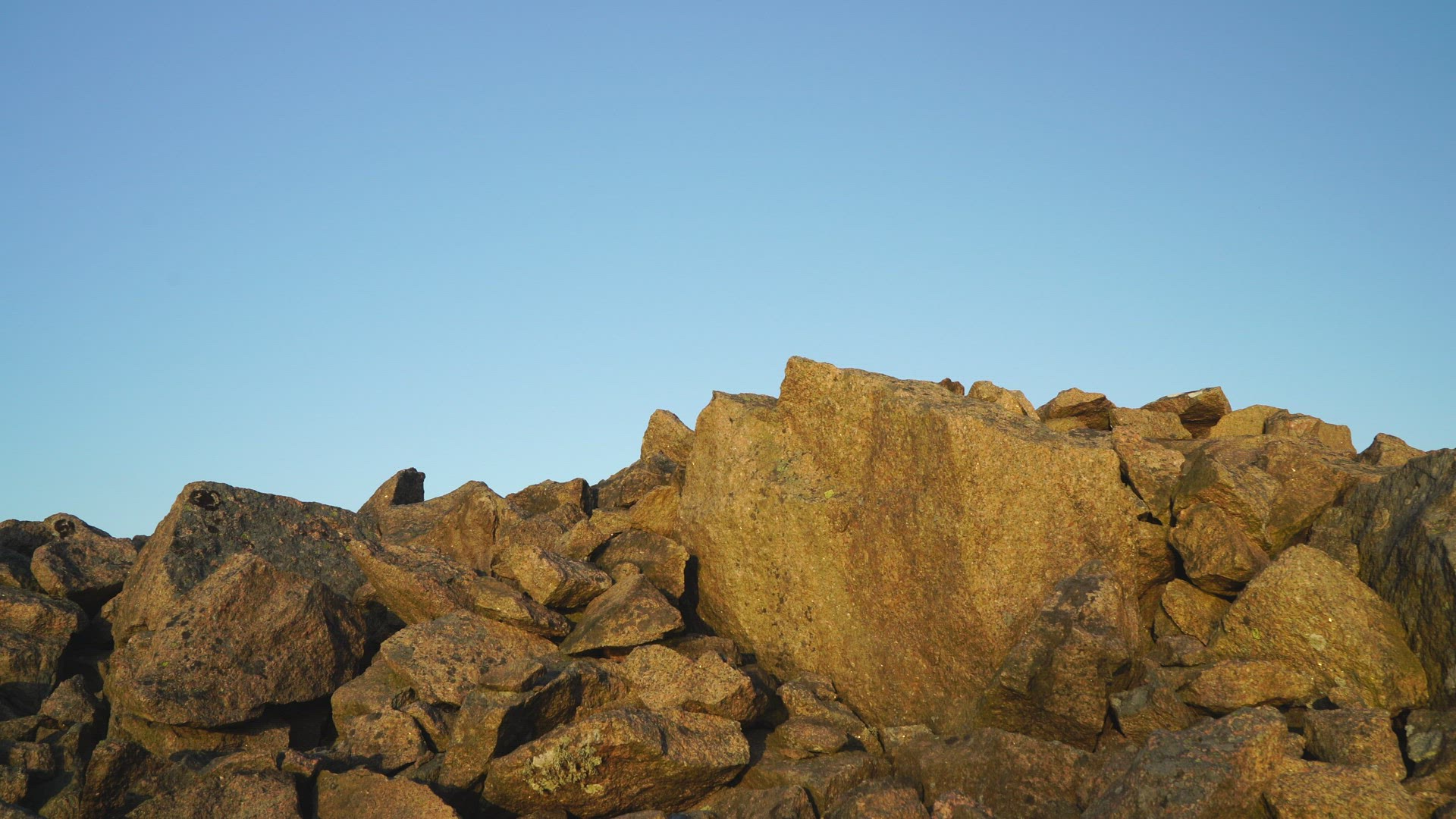 boy walking and balancing over edgy stones