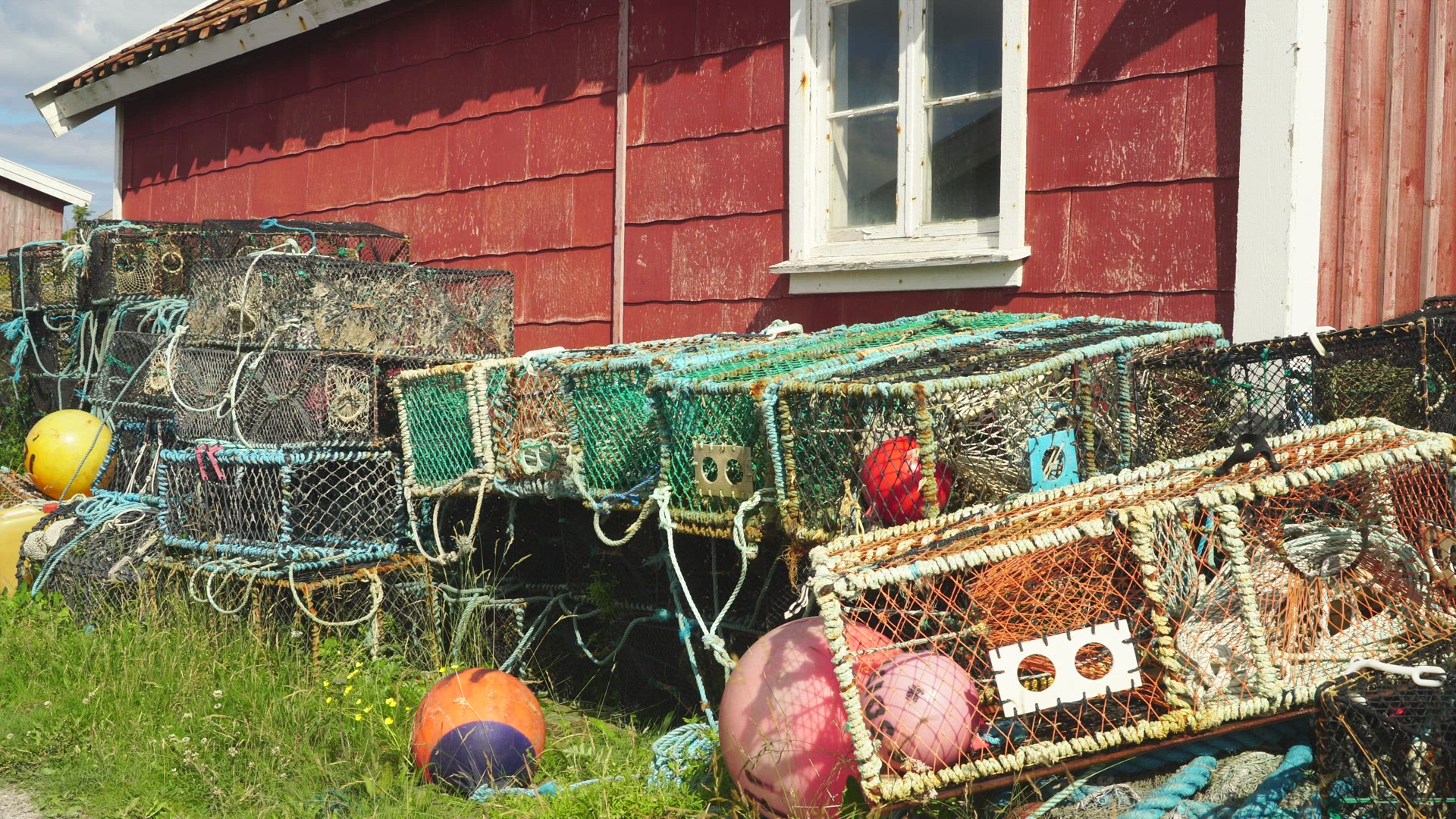 lobster pots outside small red house in Bohuslän