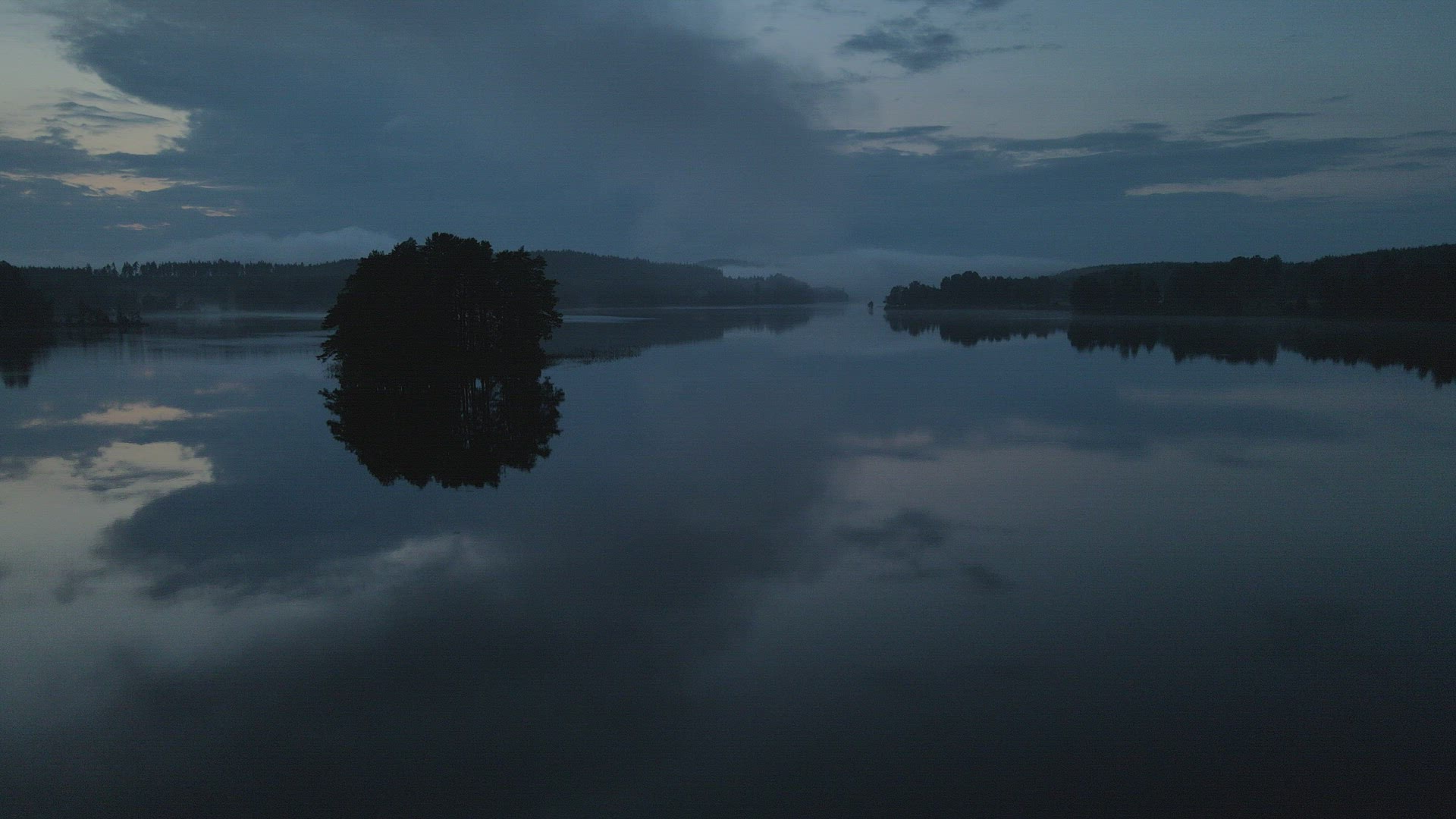 drone shot - flying over misty lake - evening shot mirror lake