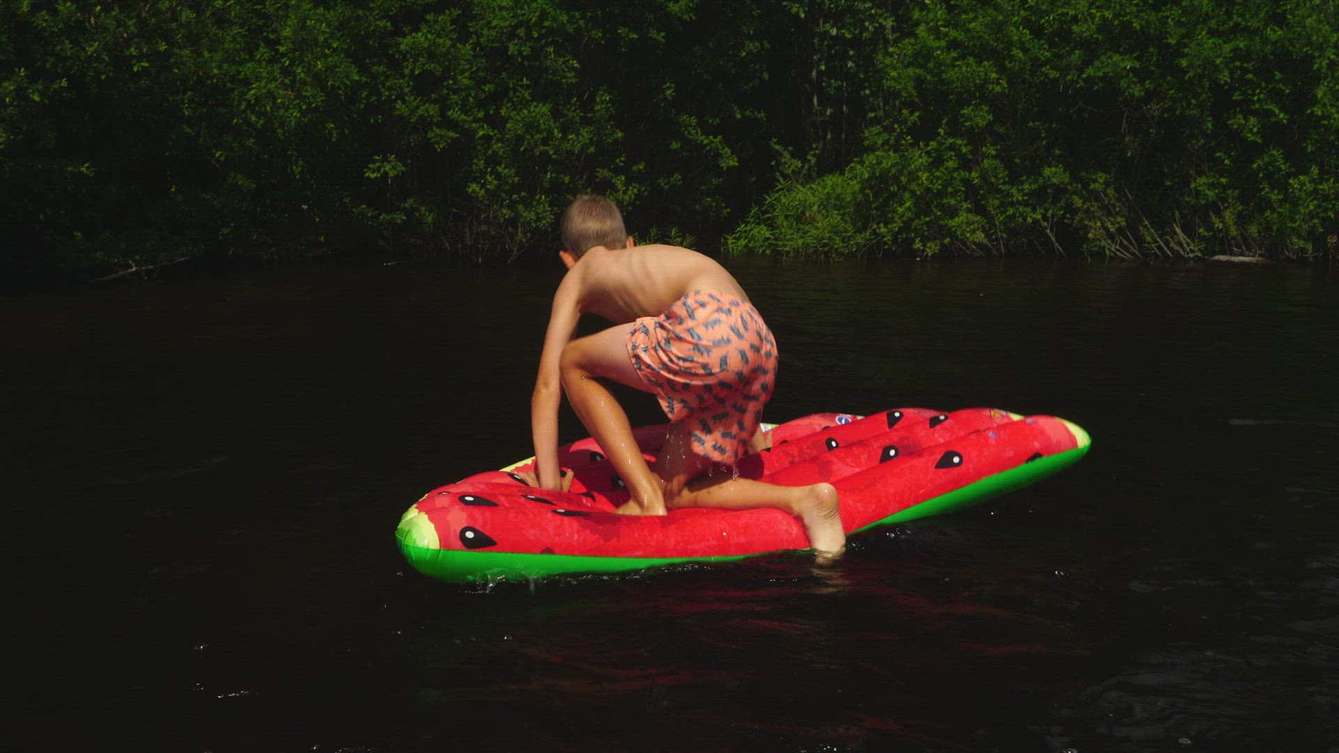 boy balancing on air mattress