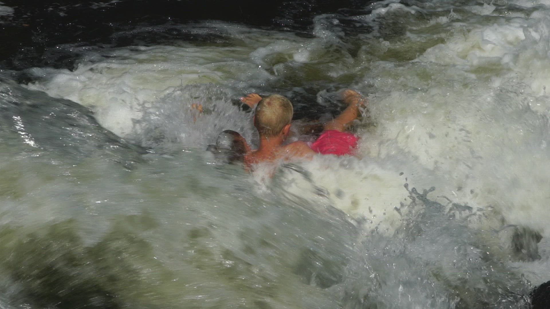 boys playing in rivers streaming water