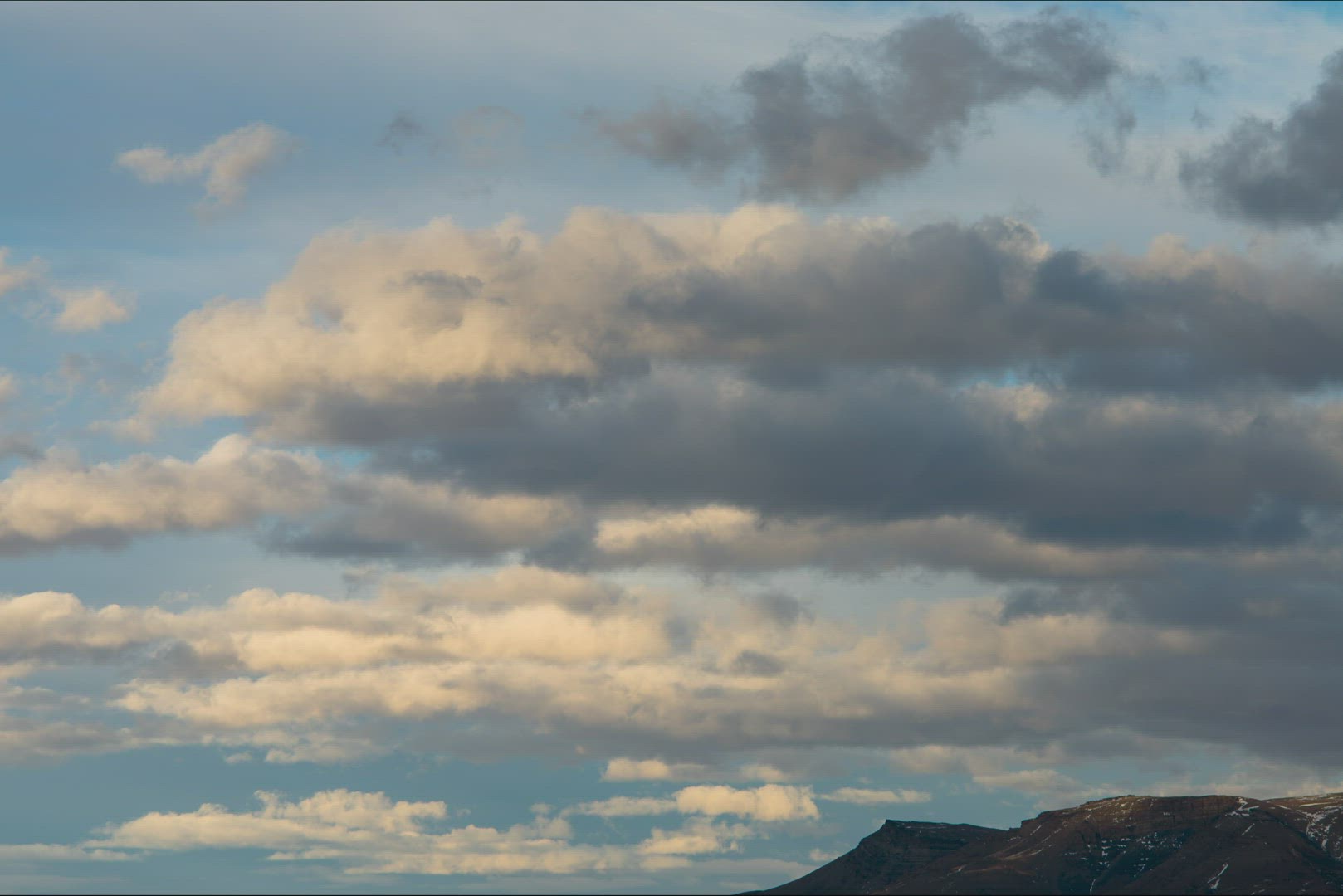 Time Lapse Of Sun Lit Clouds Rolling Under Blue Skies