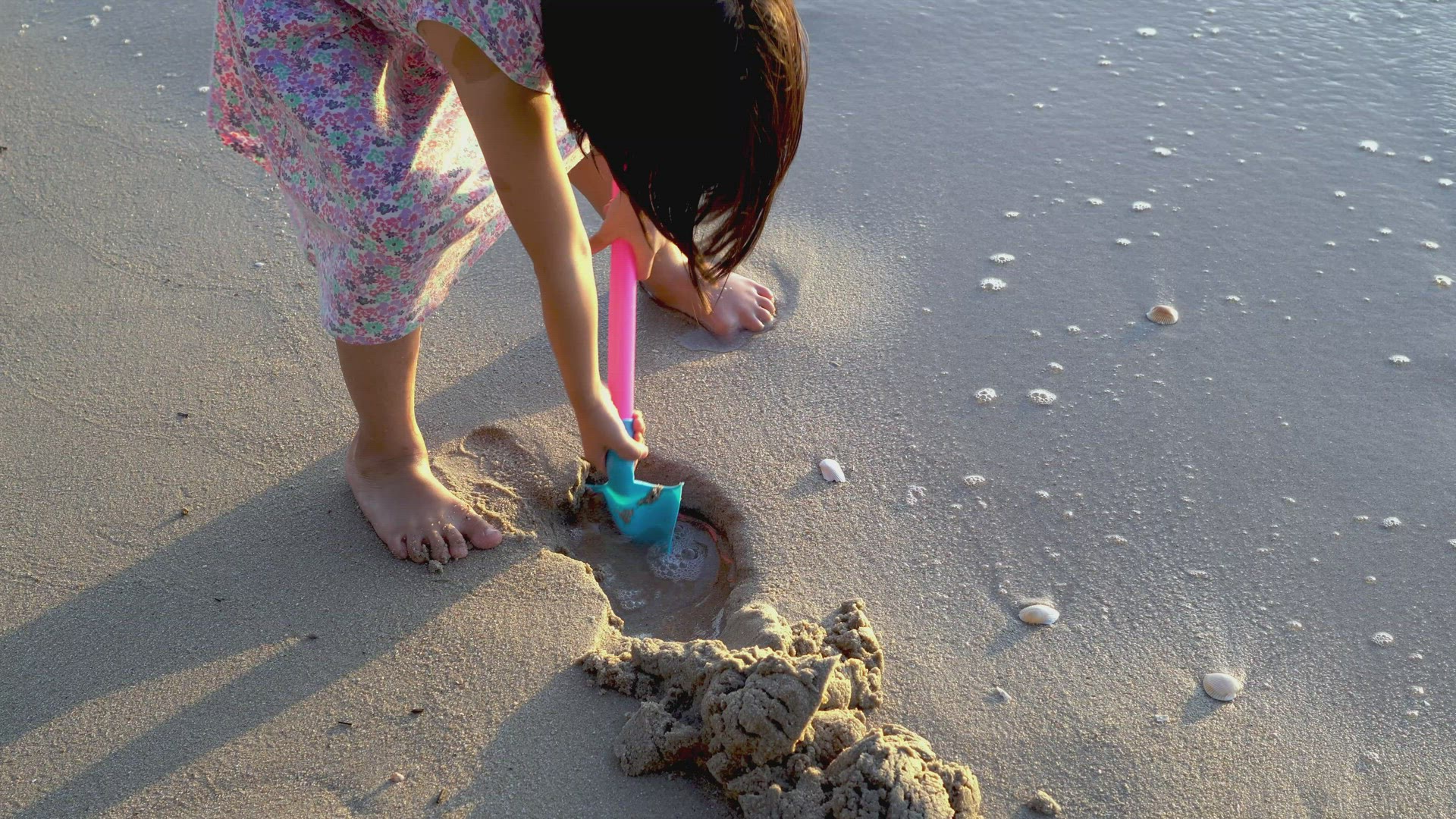 Little girl use shovel dig the sand