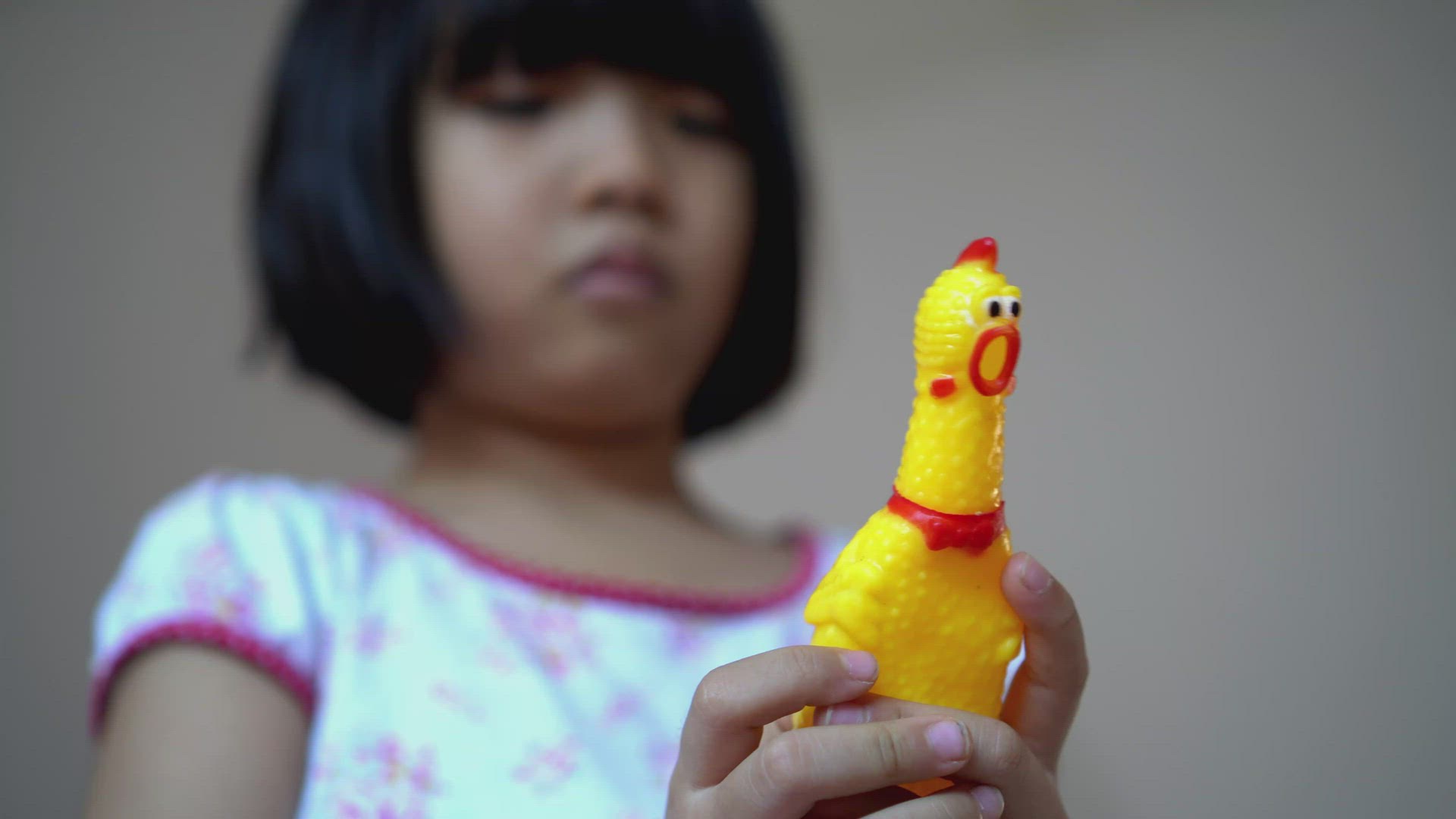 Close up little girl hand squeeze shrilling chicken