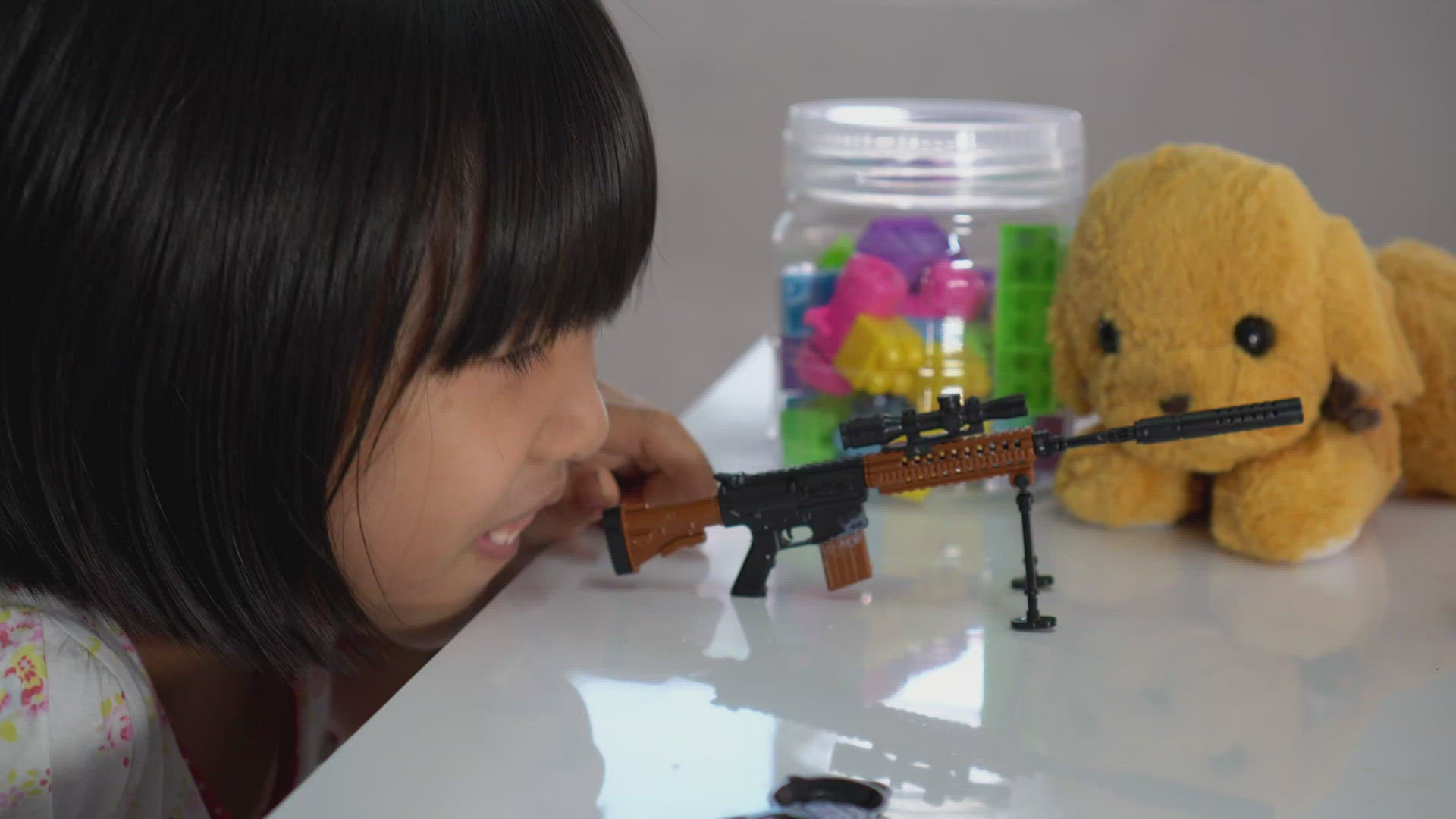 Little play and aiming with rifle toy