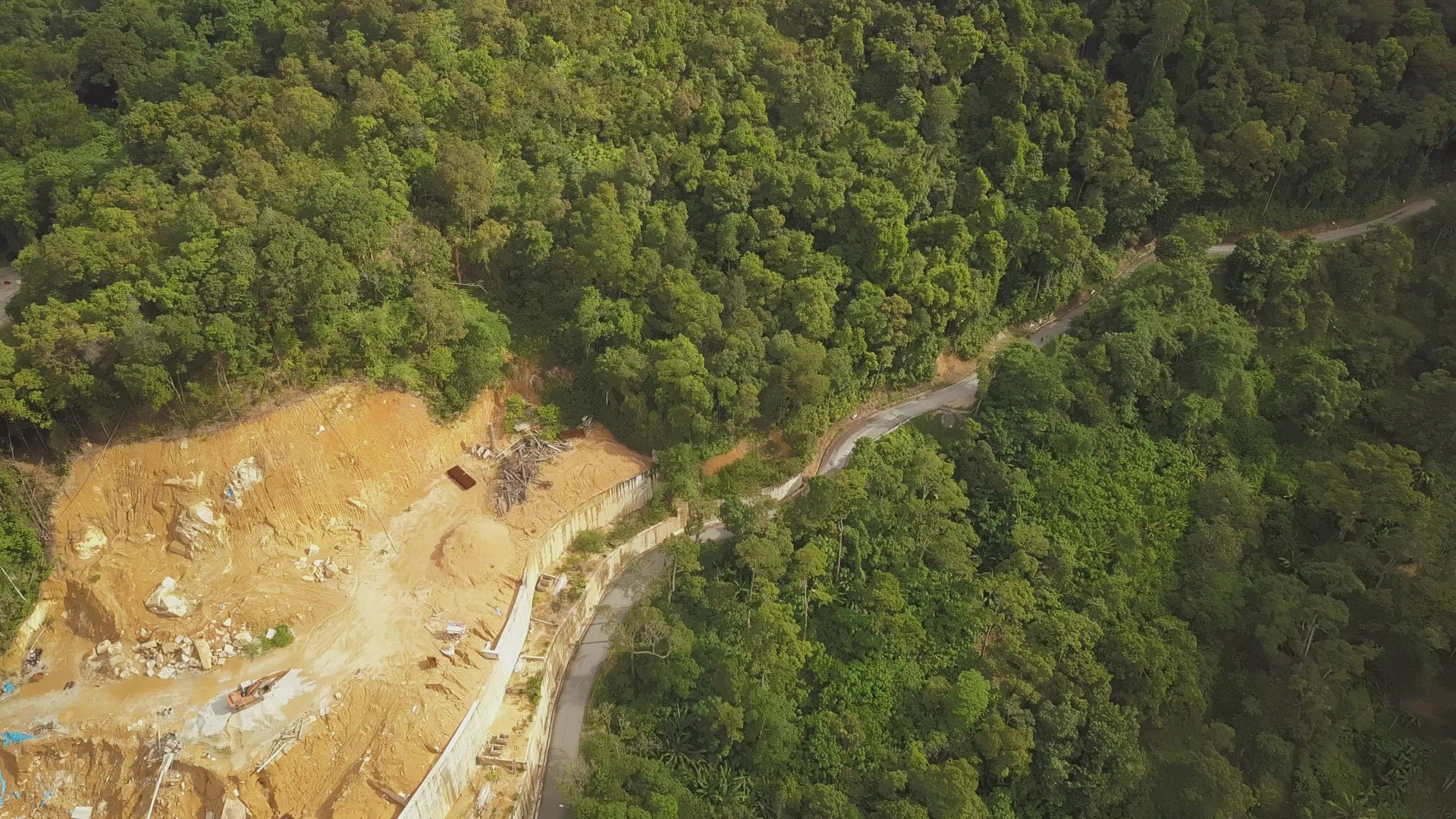 Aerial view Construction work beside the green forest at Asia country