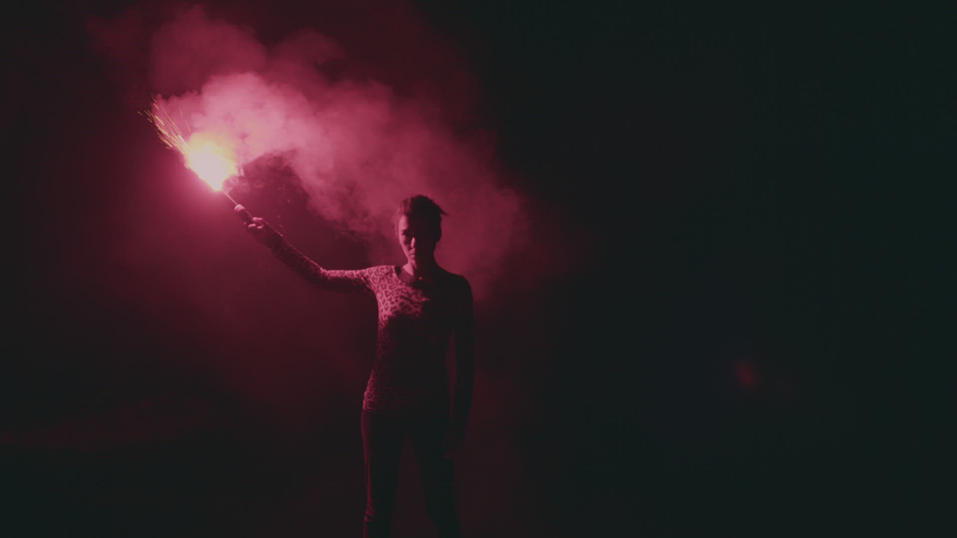 Woman with flare in the dark night