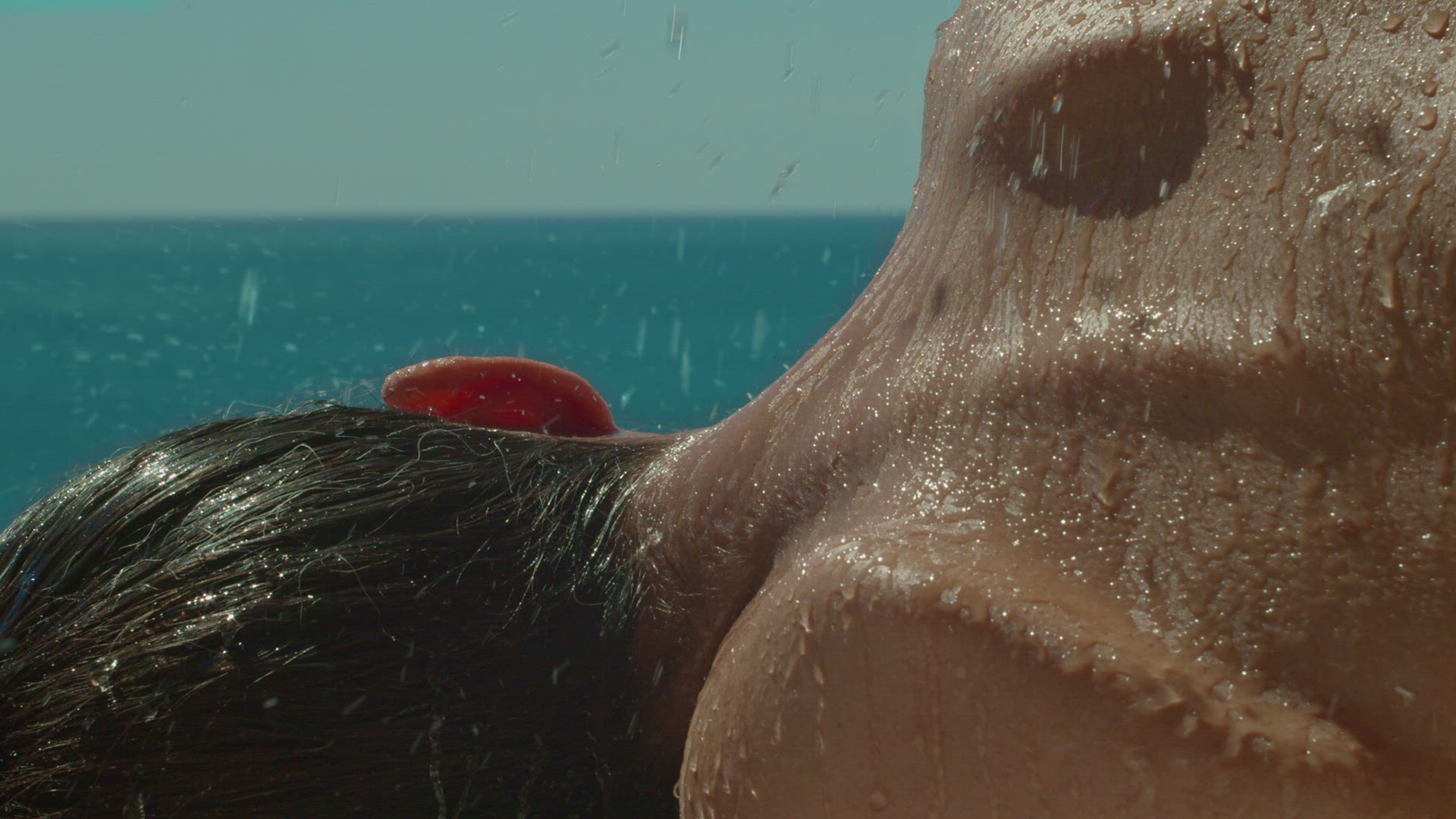 Water falling on a woman's neck in the sun