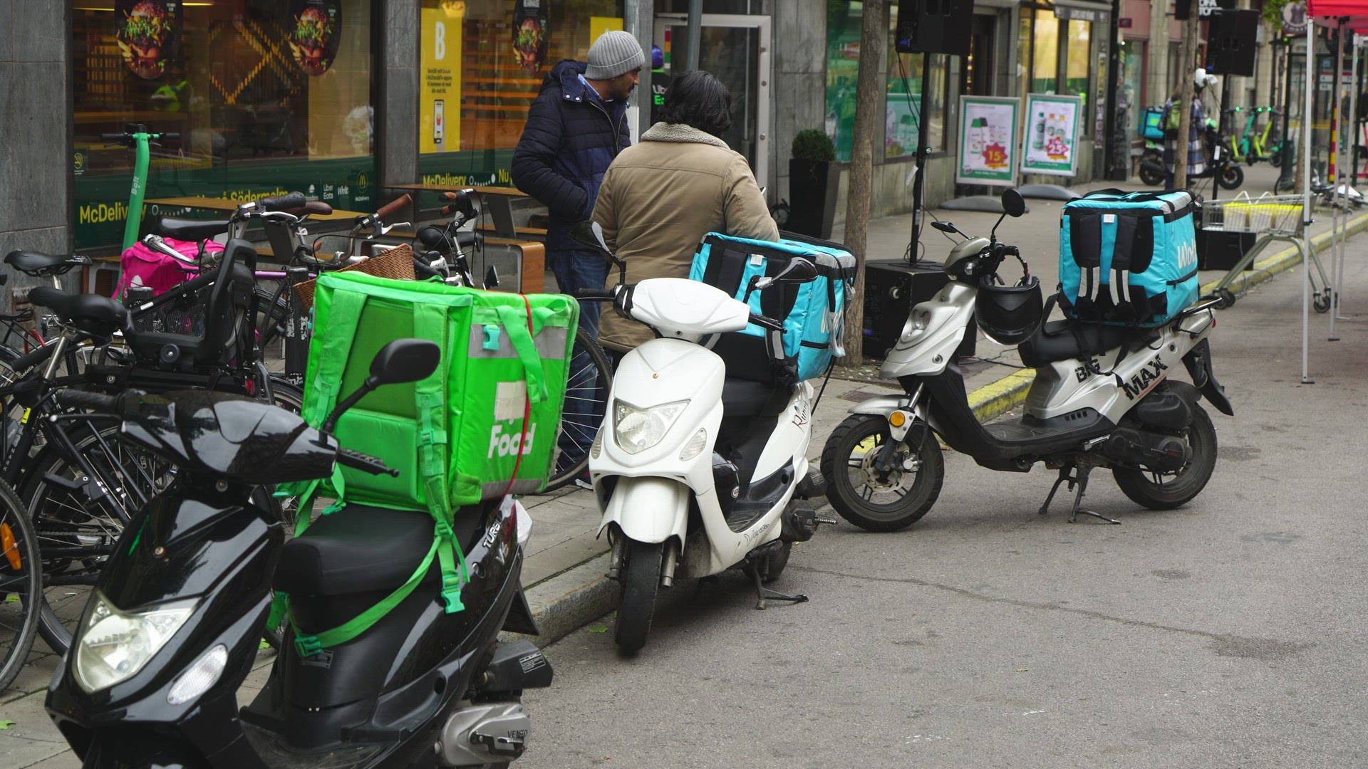 food couriers with motorbikes waiting outside restaurant in Stockholm