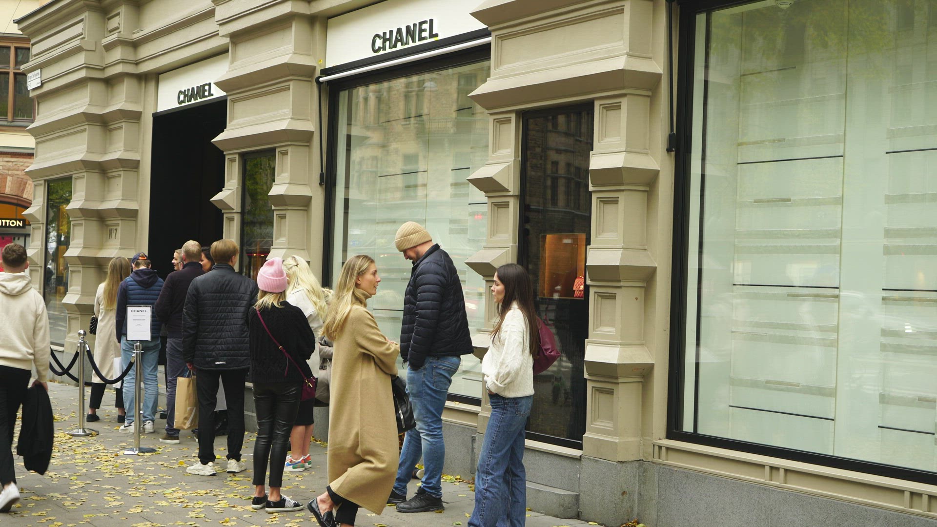 people waiting in line outside Chanel shop in Stockholm
