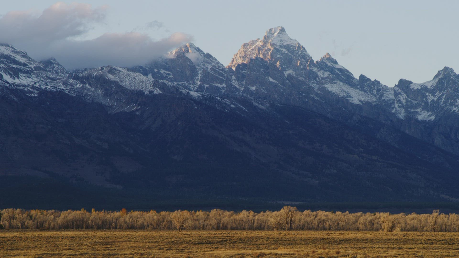 Medium shot of Grand Teton mountains at sunset