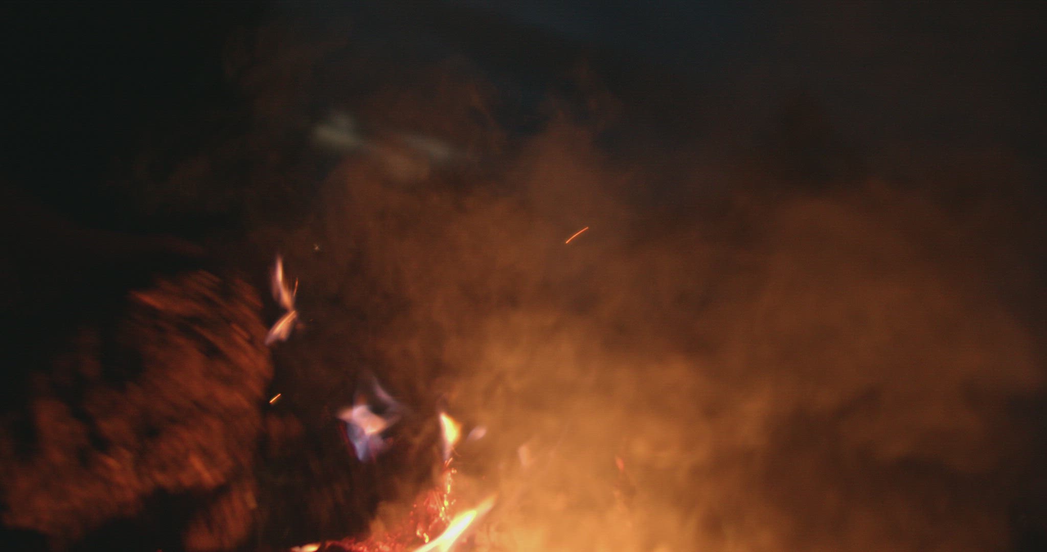 Sparks from bonfire at night