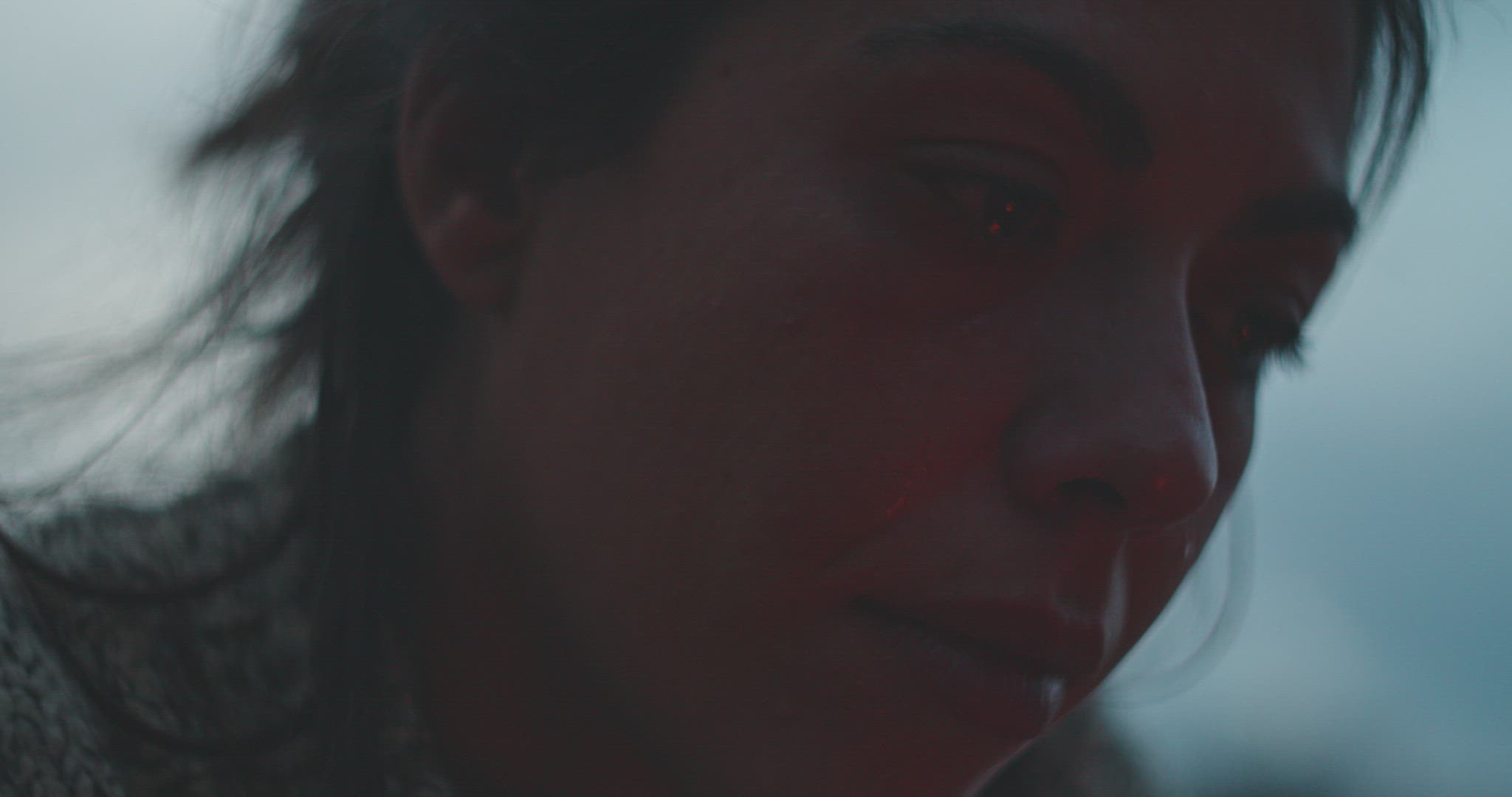 Woman cries next to fire
