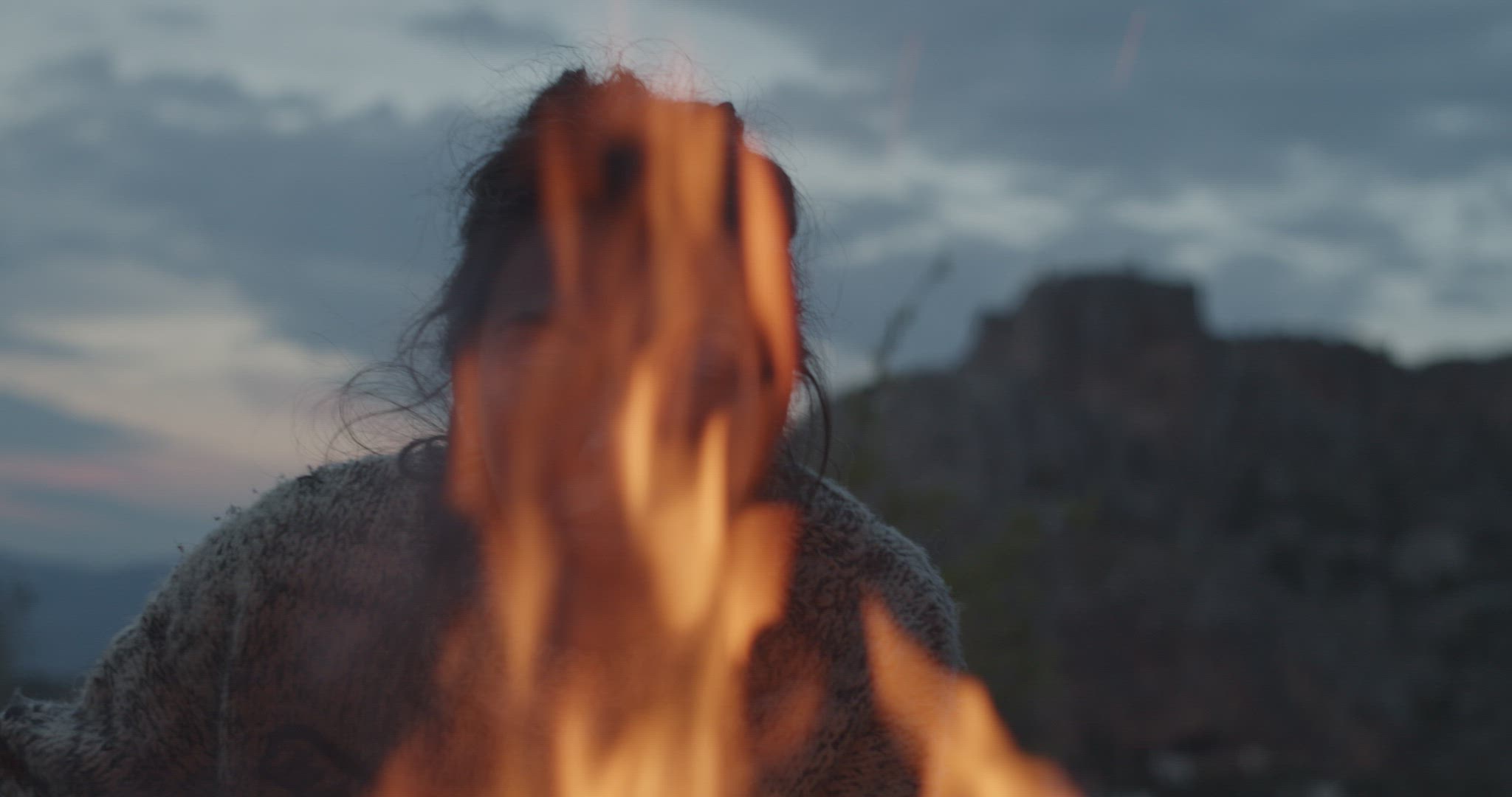 Woman runs her hand through the fire
