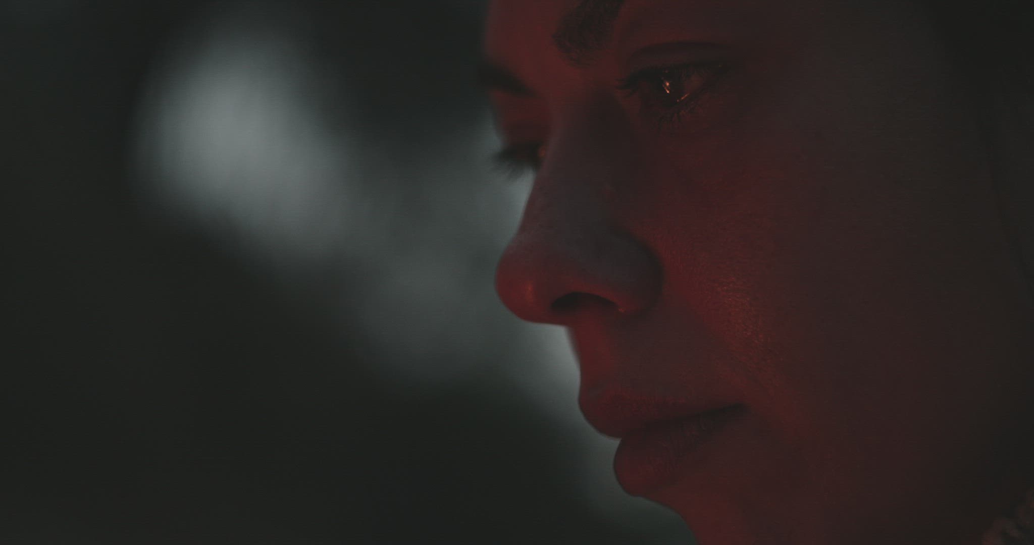 Woman with bonfire reflected in eye