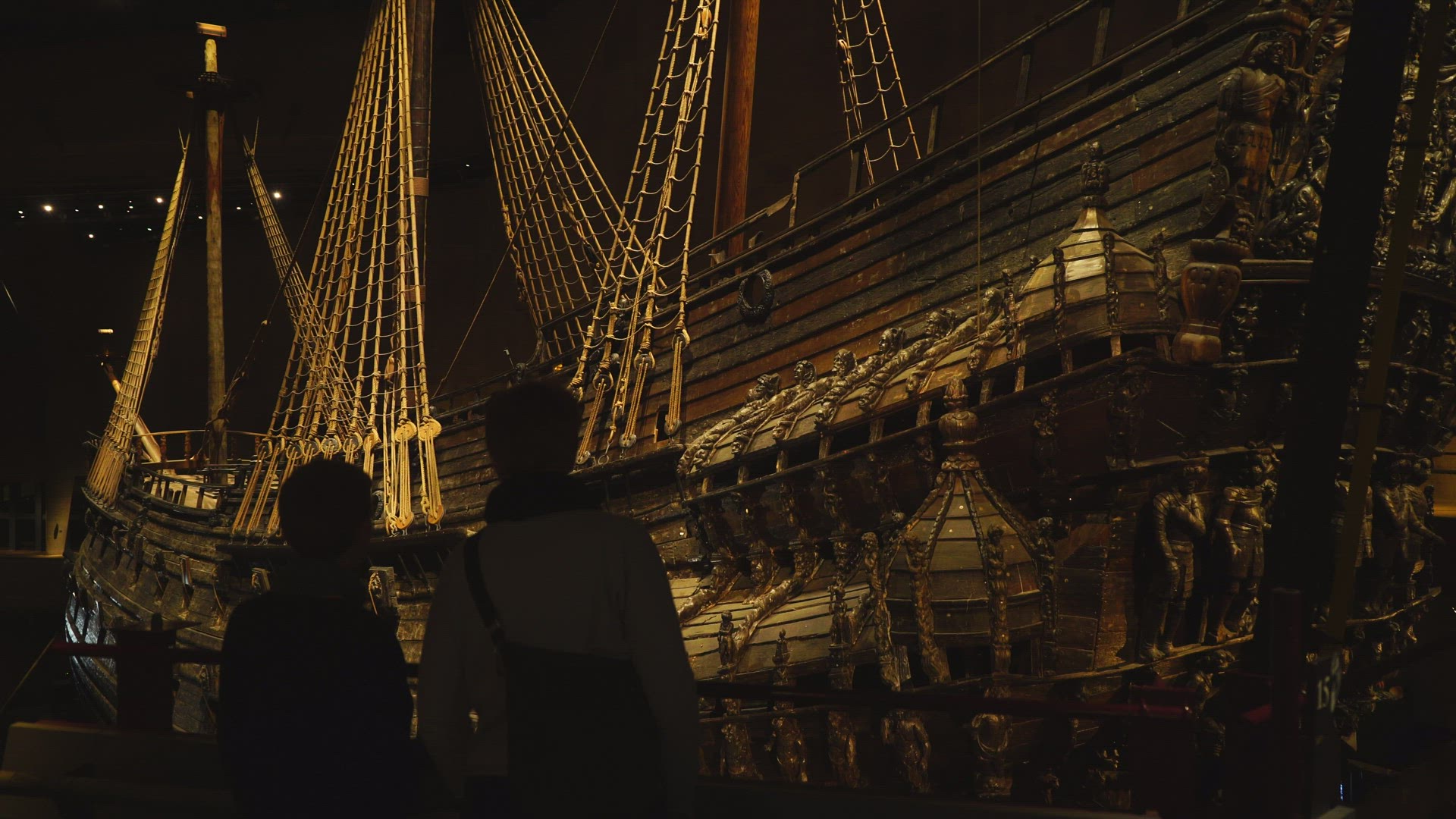 mother and child watching old warship Vasa at museum in Stockholm