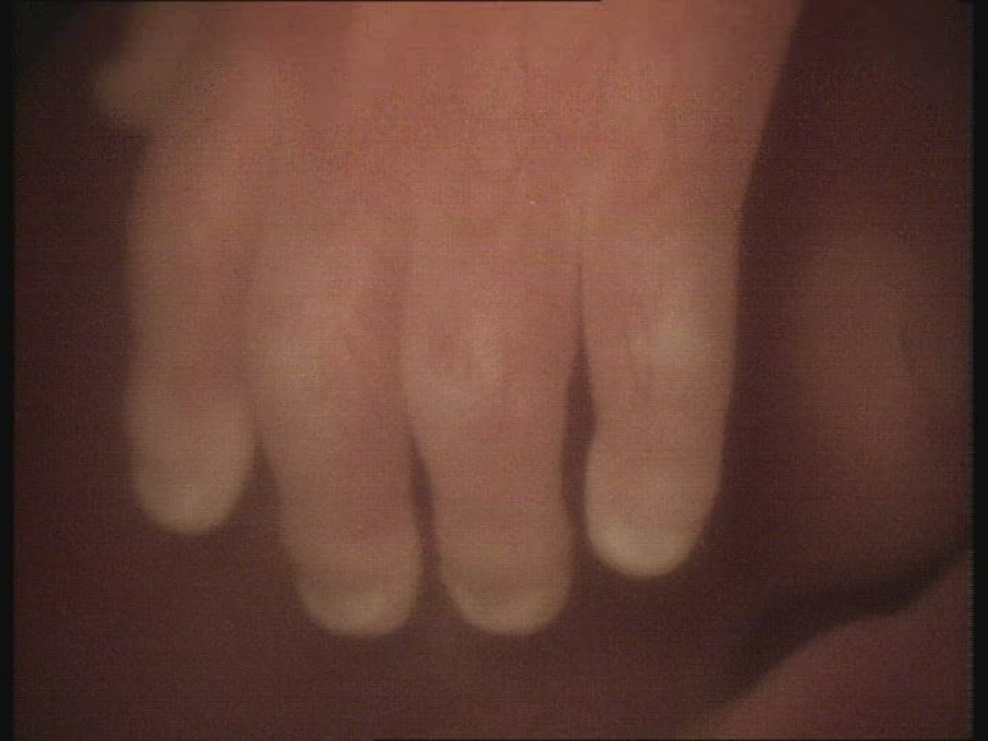 Foetus in the womb. Hand to reveal face