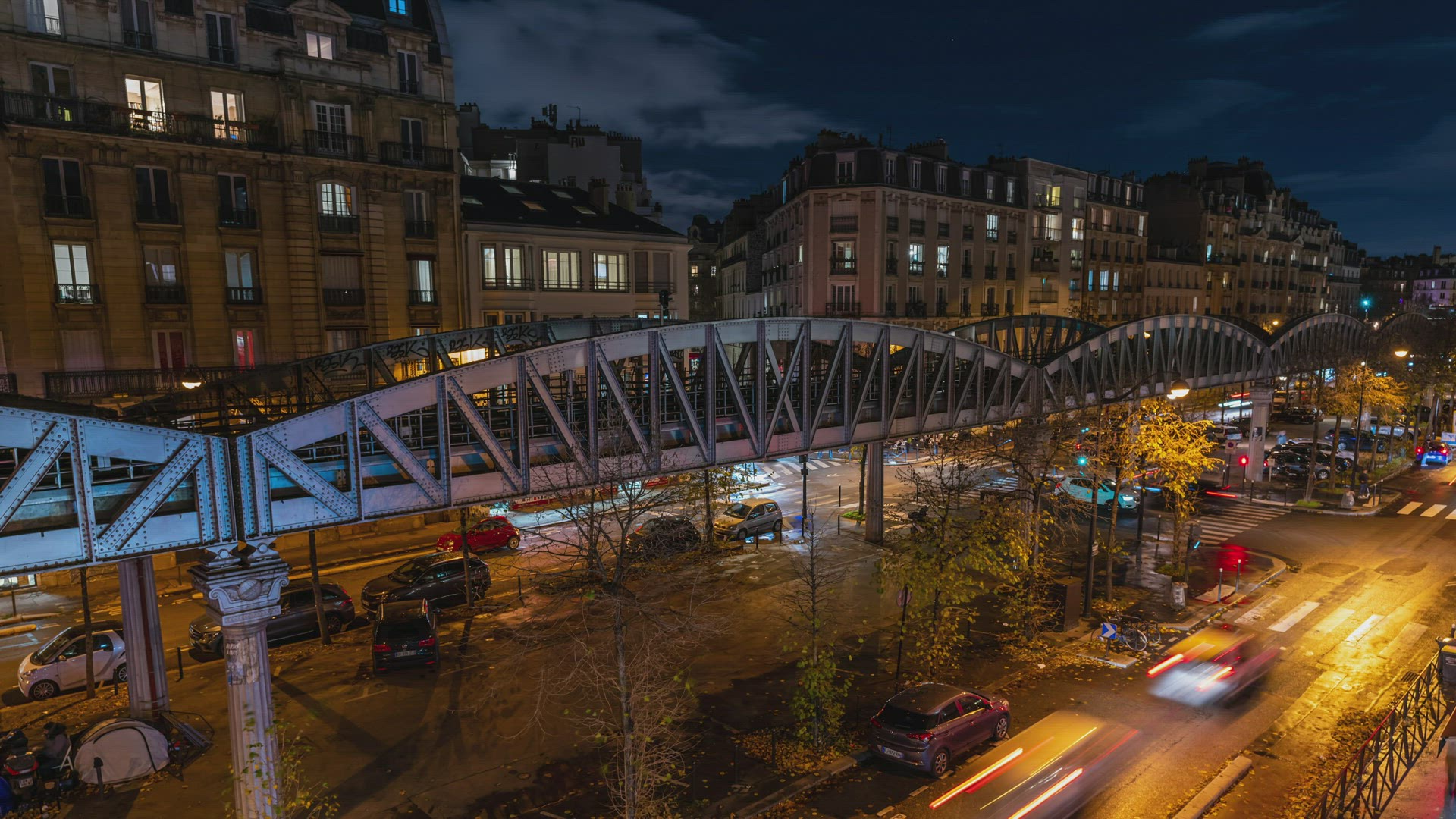 Time Lapse of a busy street and an elevated metro train bridge in Paris