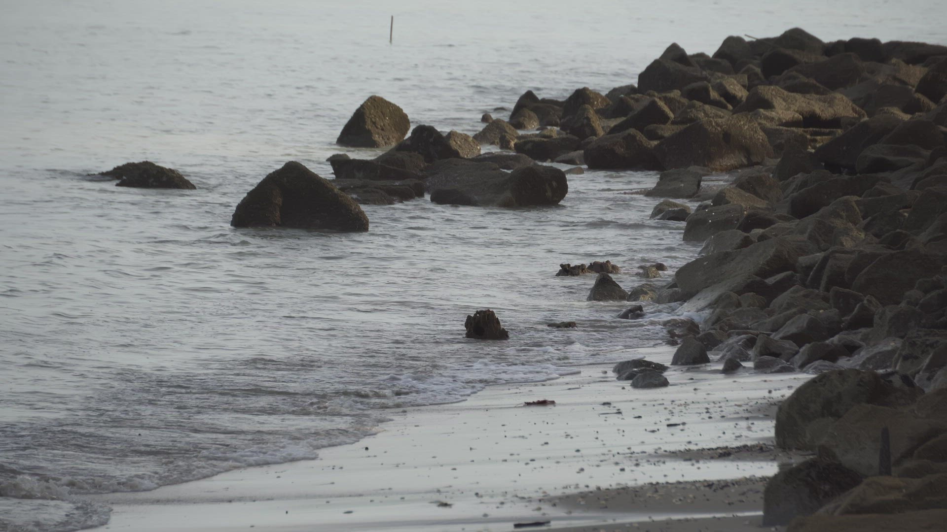 Sea water hit the brown rock