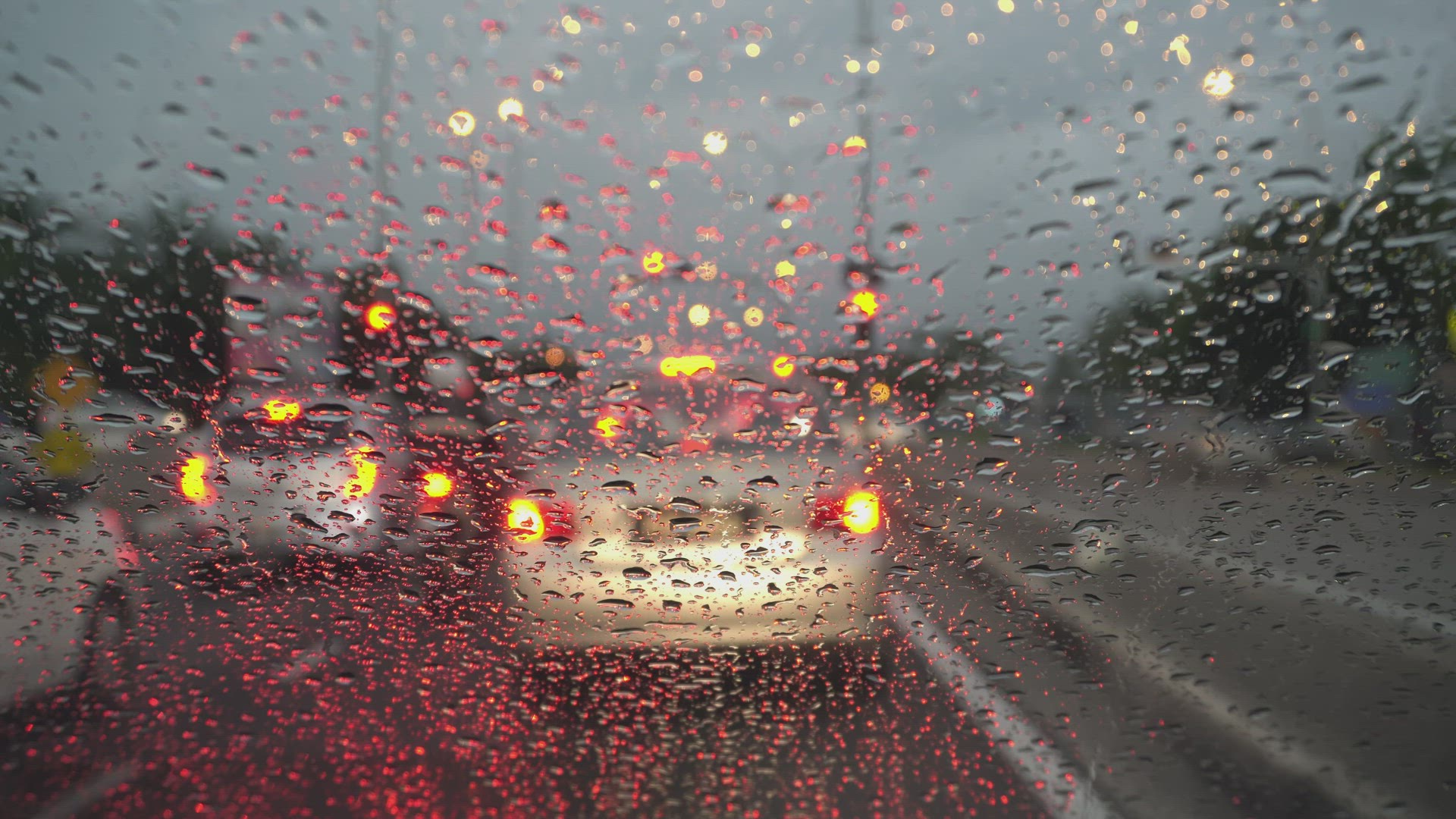 Selective focus rain droplets falling down at windshield