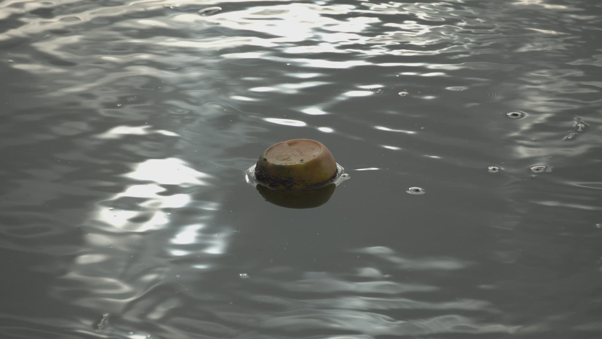 Ripple of water near plastic bottle.