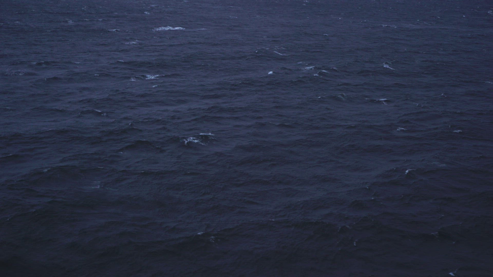 pov from ferry - side view over sea and waves - dark water