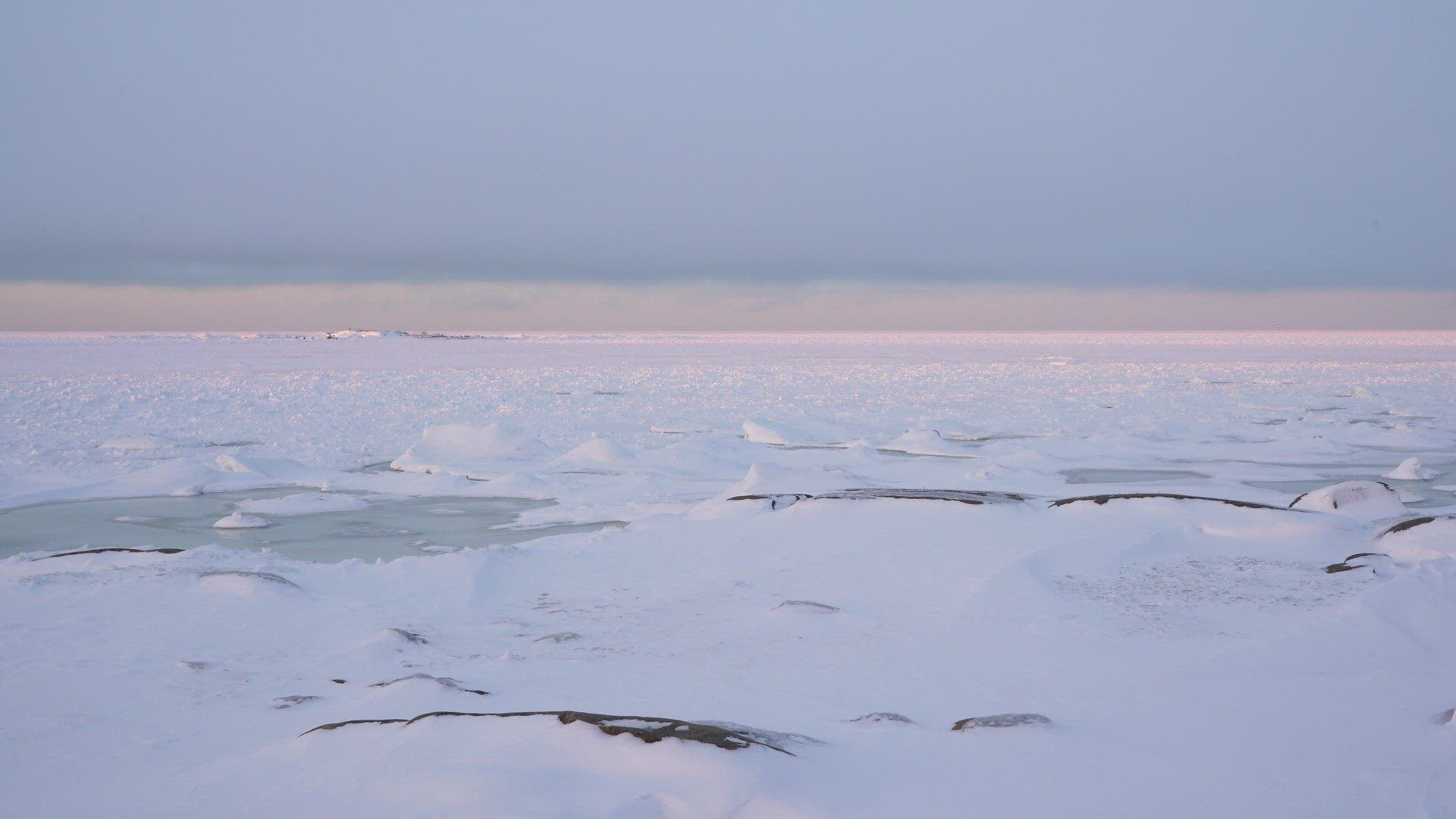 boy walking in snow in icy coastal landscape at Fäboda, Jakobstad in Finland