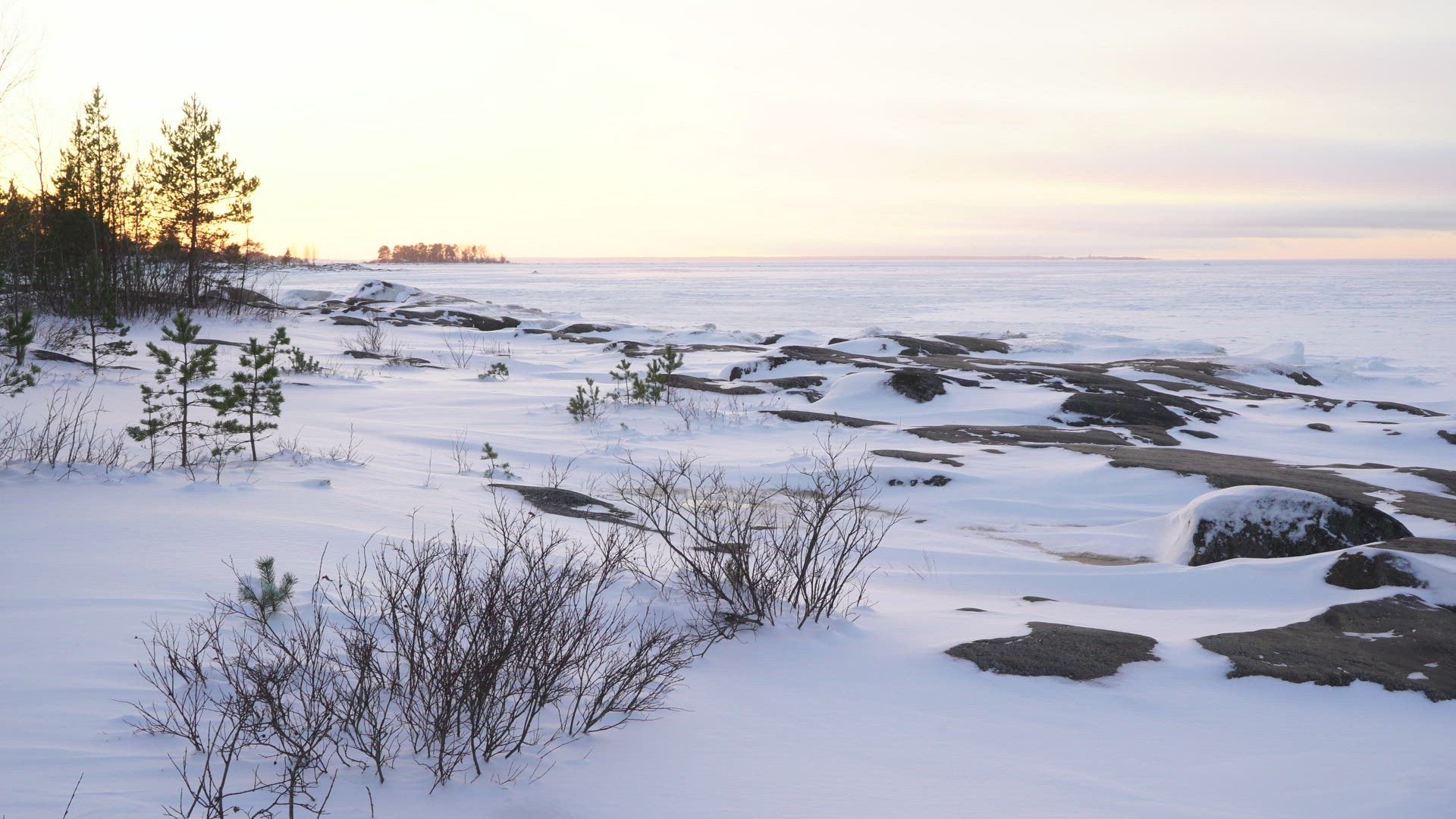 view over coastal landscape at Fäboda in Finland - snow and ice at sunset
