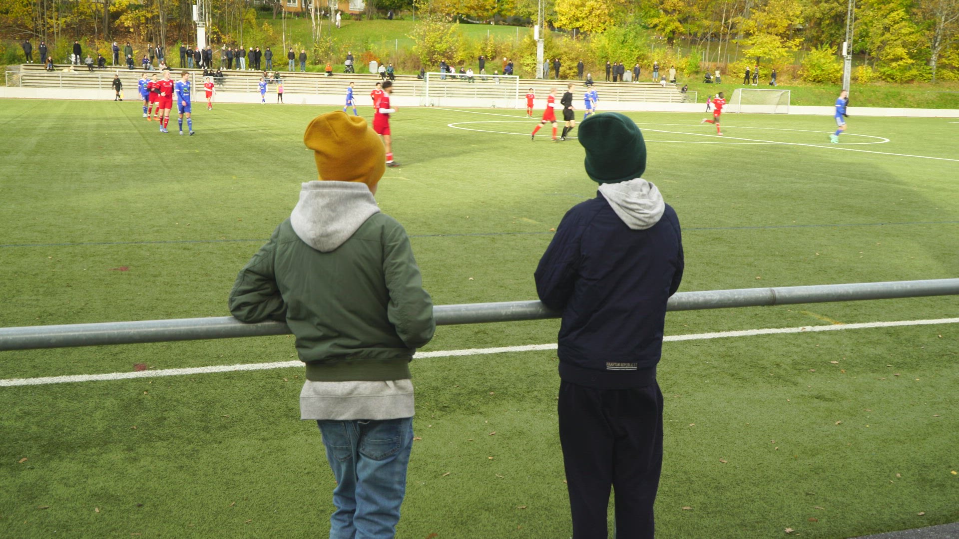 boys watching soccer game - soccer field