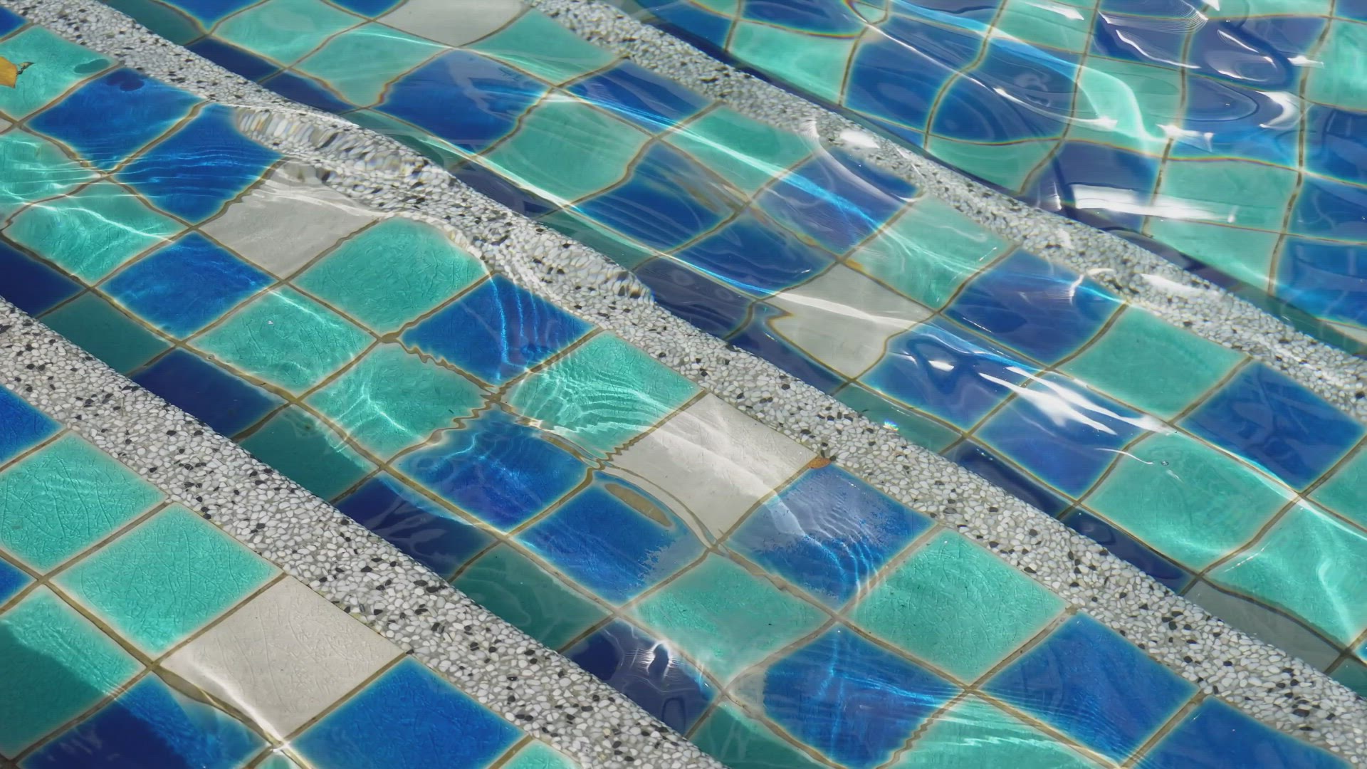 Gentle smooth water flow at the stair of pool