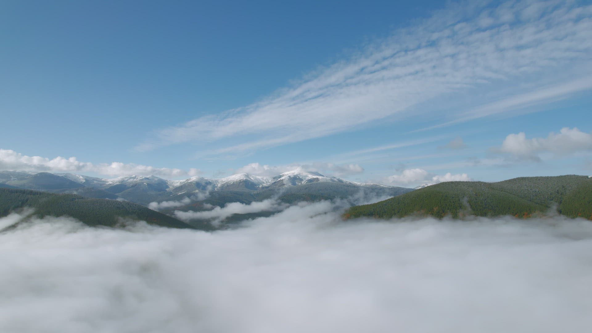 Establishing Aerial View Of Beautiful Clouds Above The Clear Sky And Mountain High