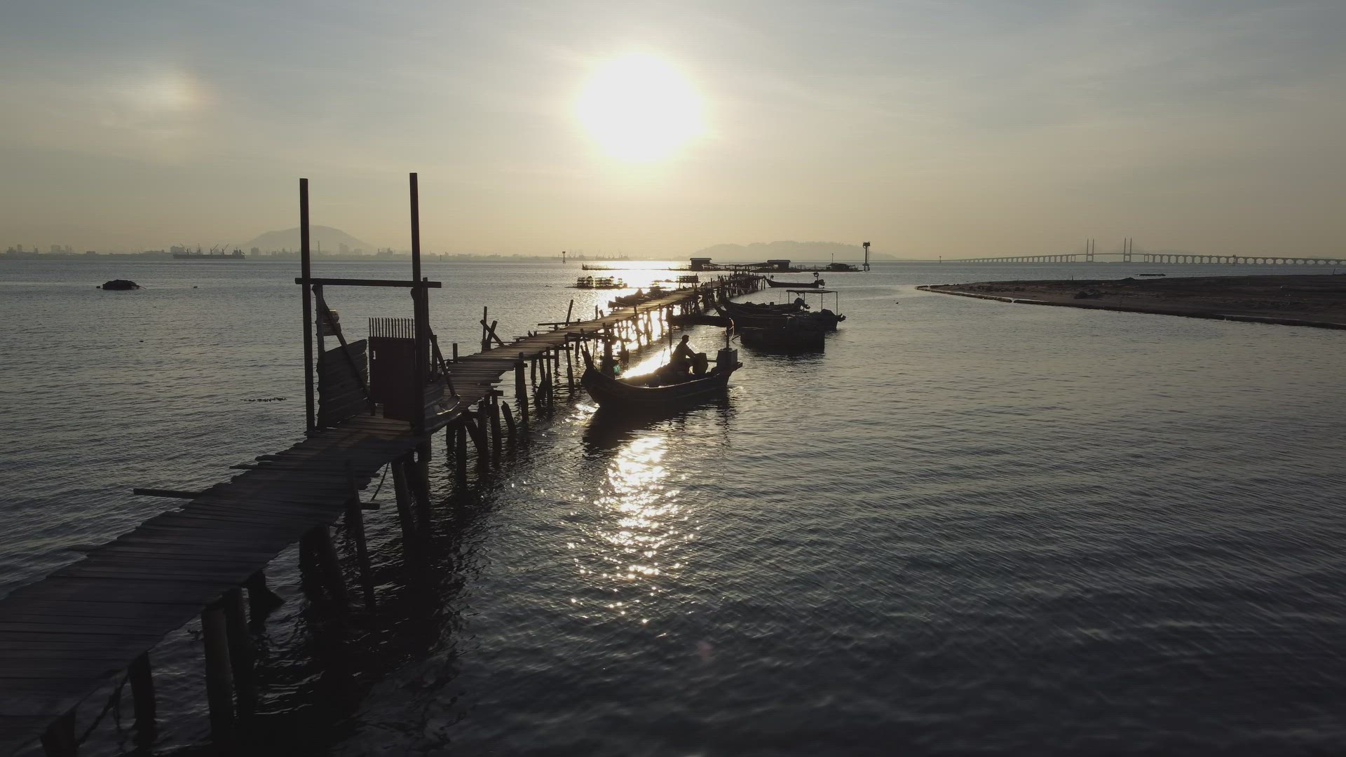 Fisherman on the way go to sea from wooden jetty.