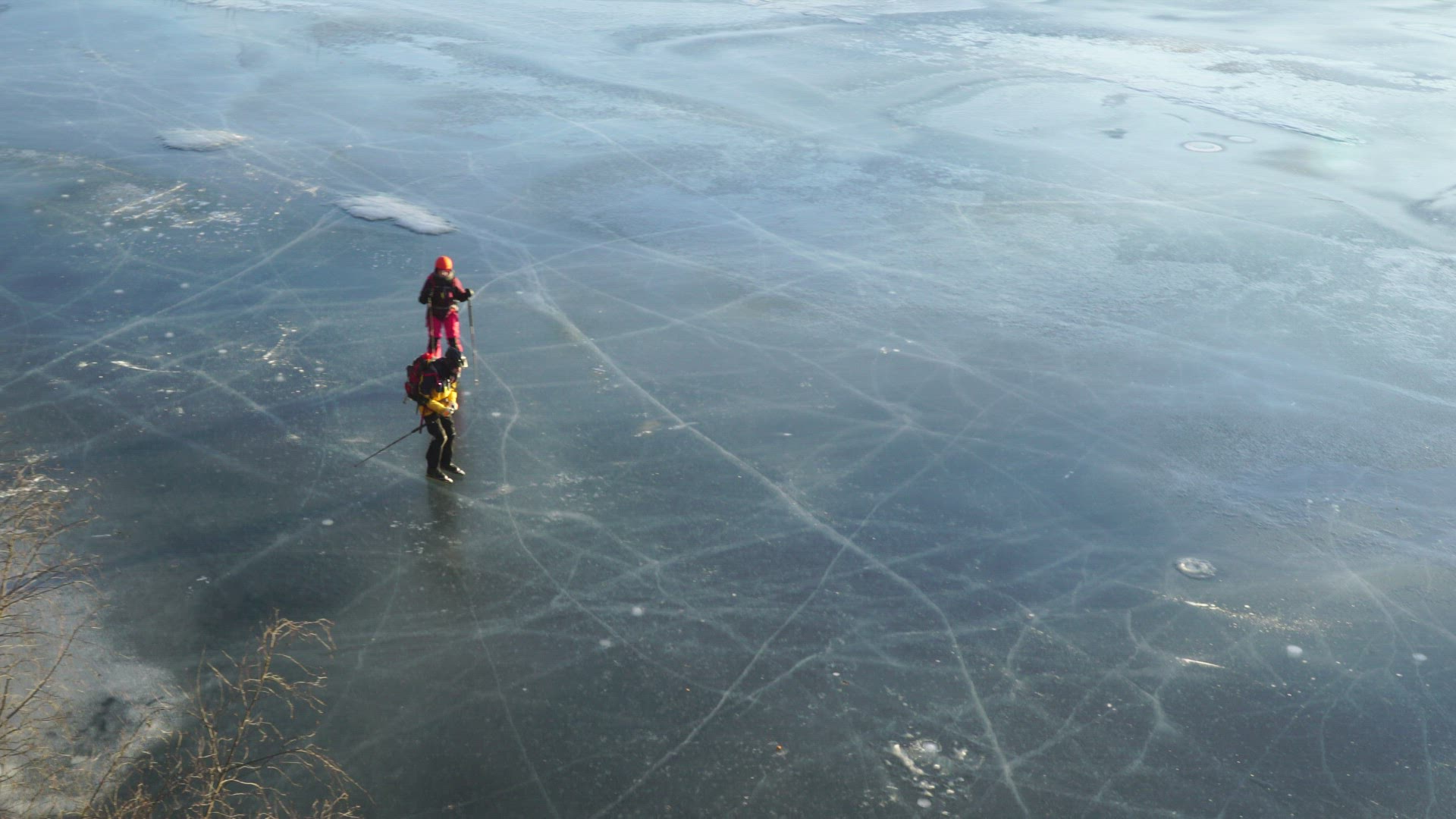 long-distance skaters on ice - frozen lake in sweden