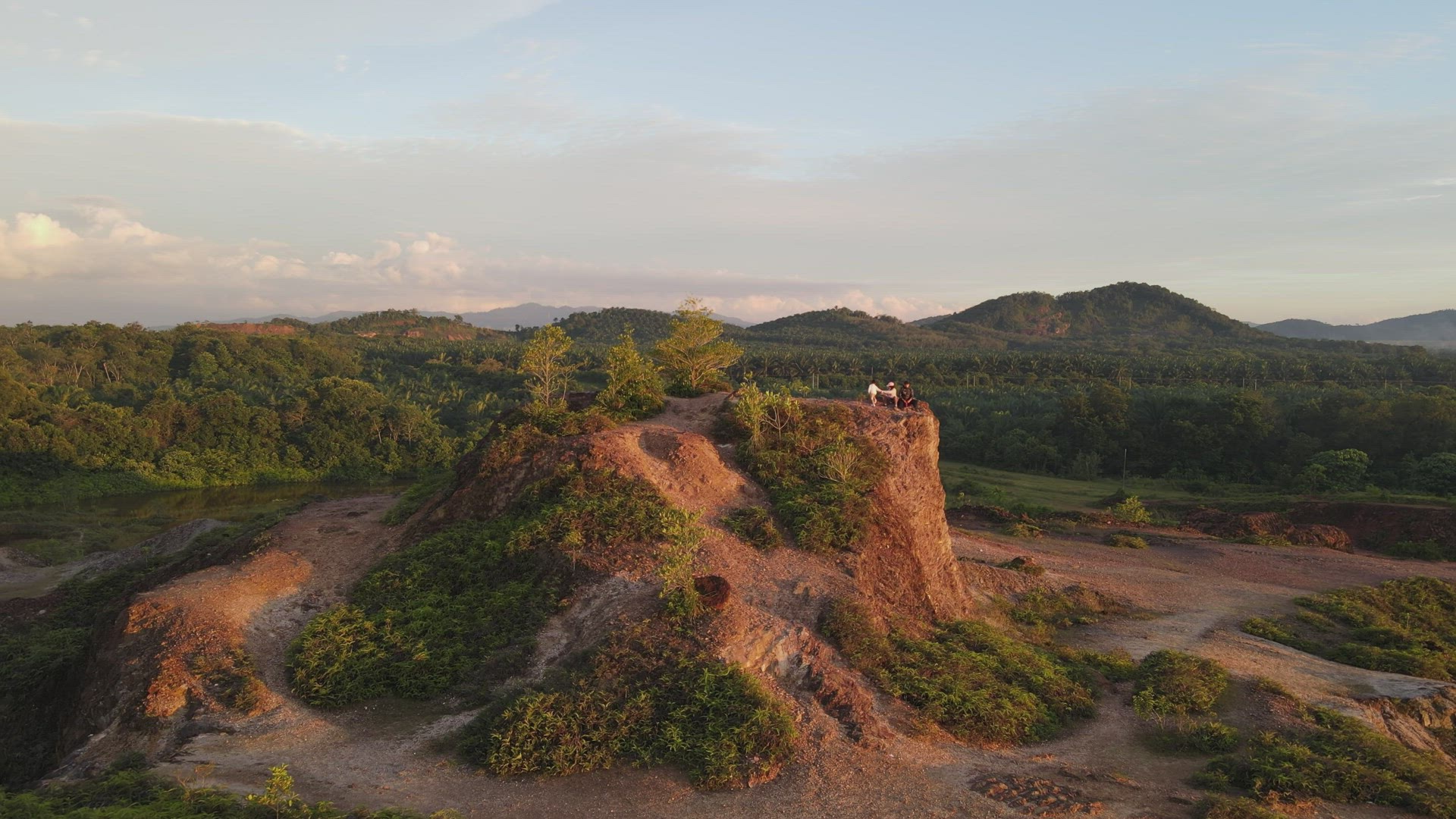 Aerial fly toward family enjoy scenery at small hill