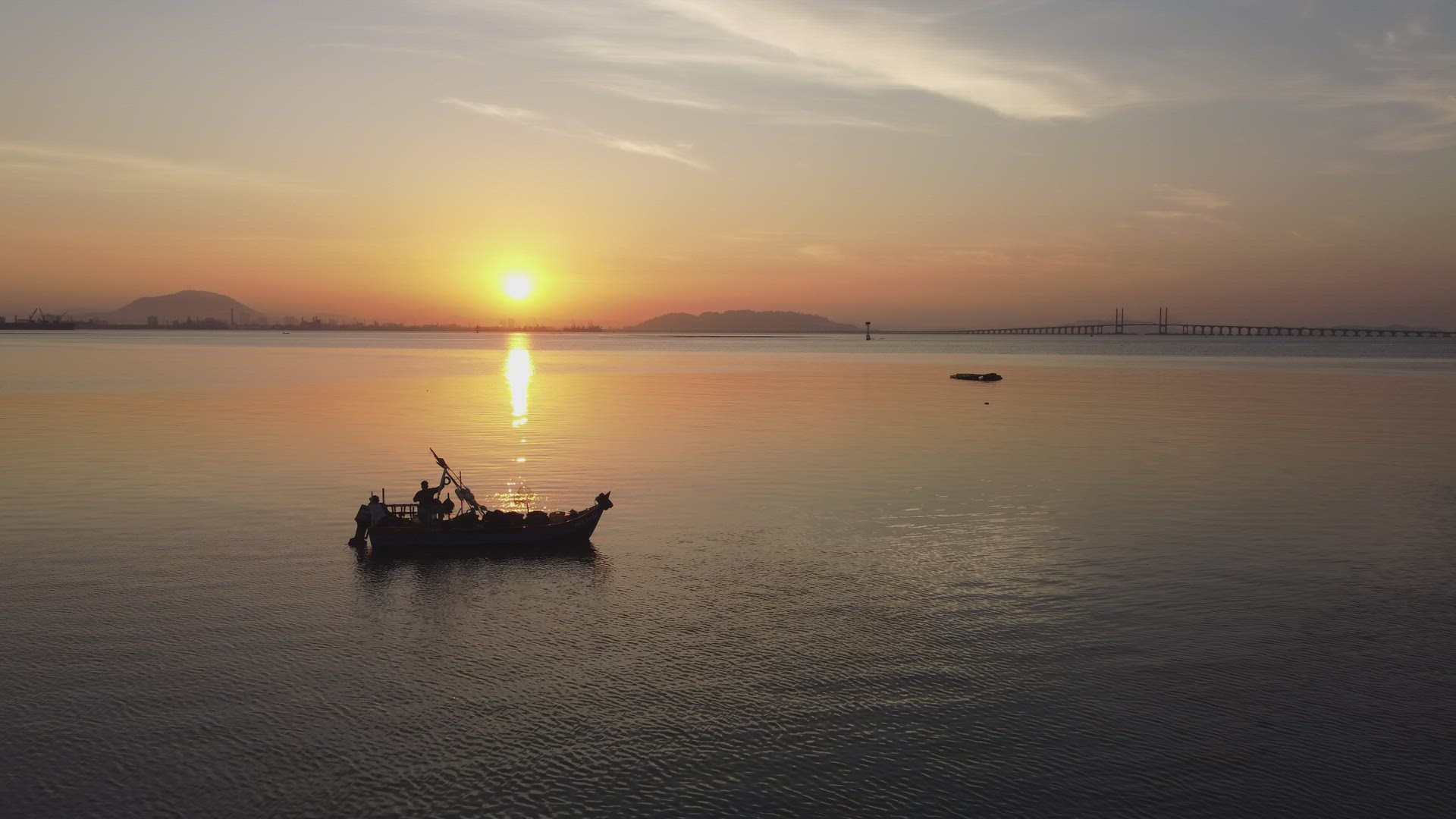 Silhouette of fisherman at sea.