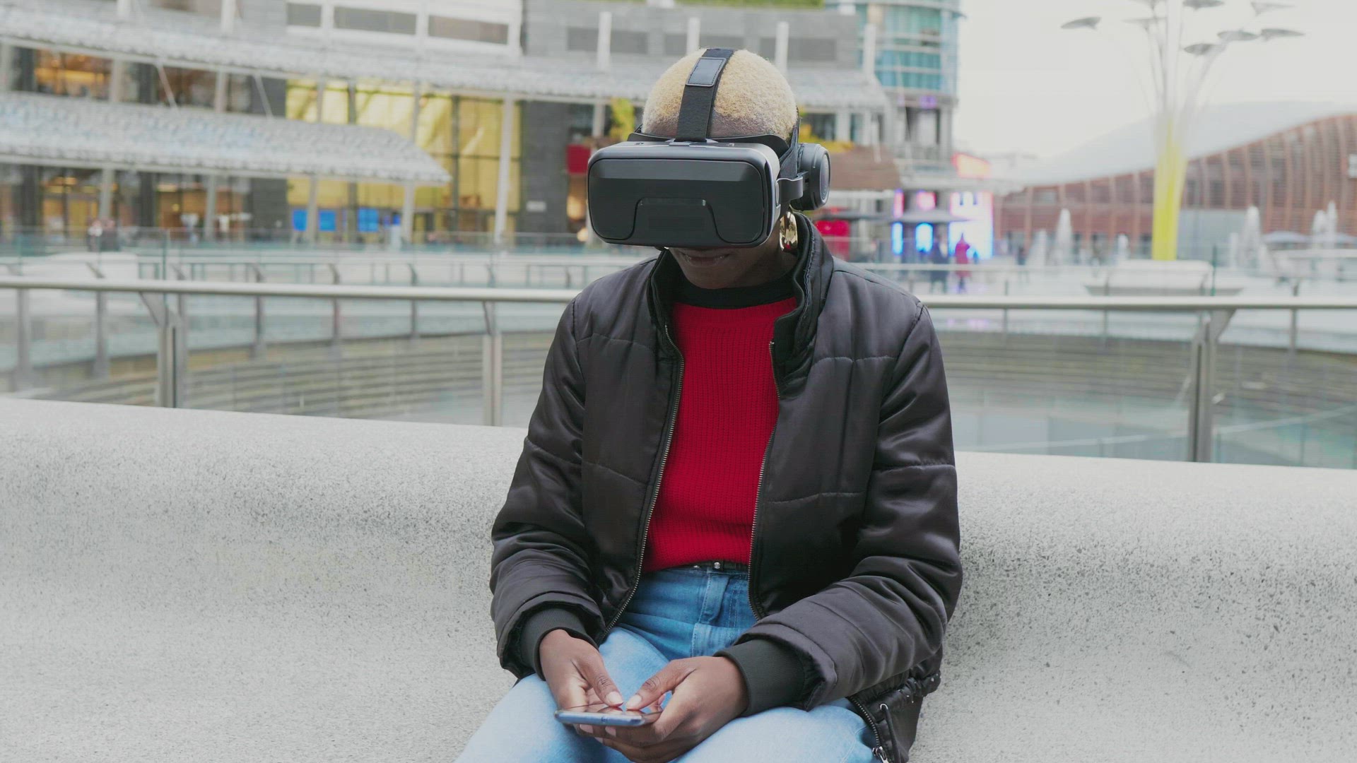 MS Woman with VR goggles and smart phone in city