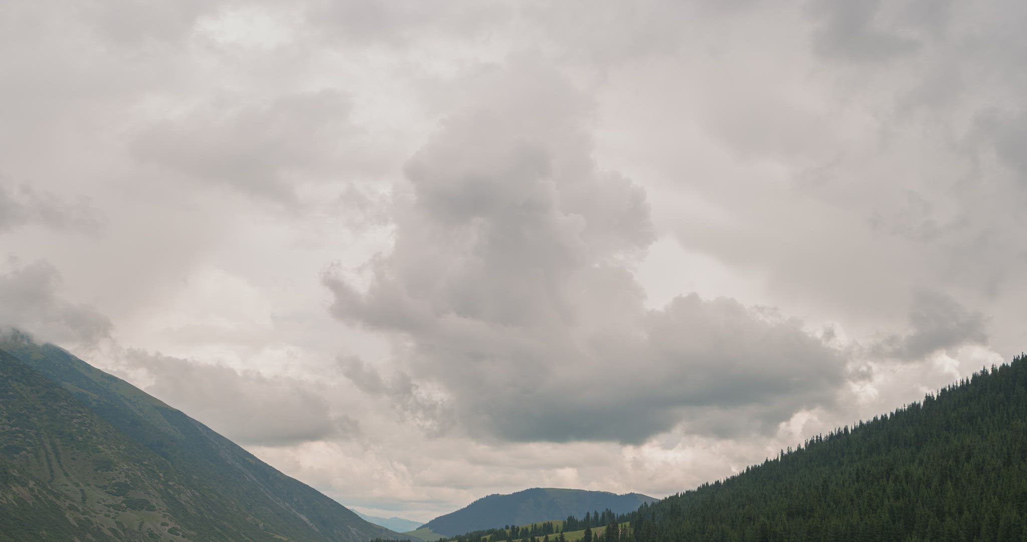 Clouds over the mountains. Grigoriev gorge, Issyk-Kul, Kyrgyzstan. Time Lapse