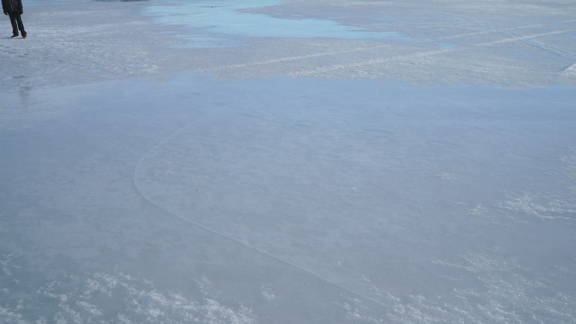 boy running and gliding on lake´s ice